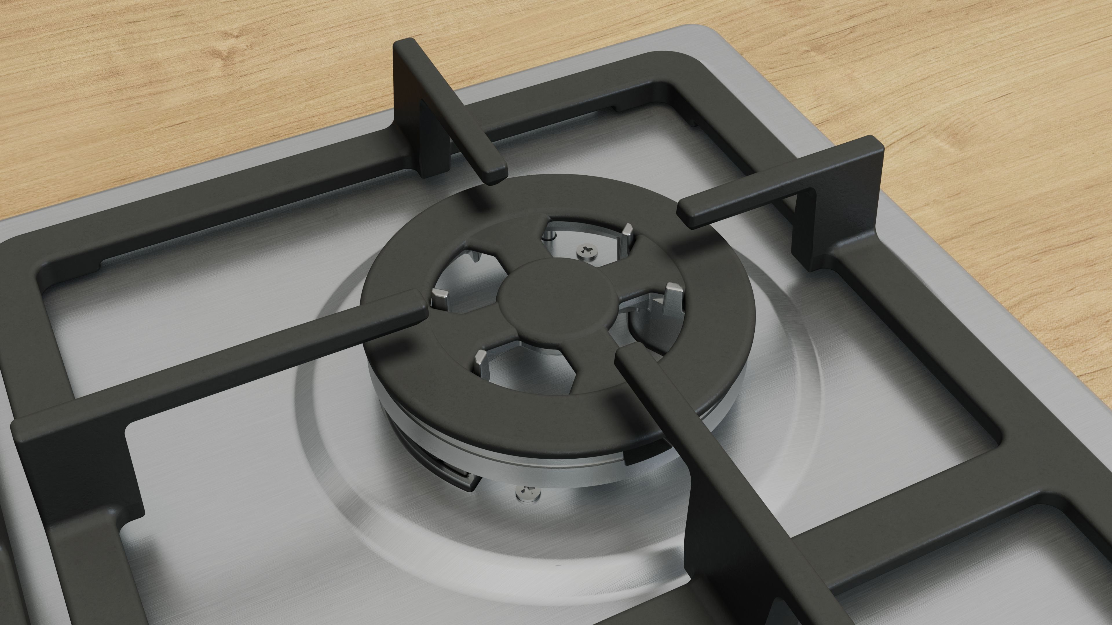 Zbliżenie palnika gazowego z czarnymi wspornikami i srebrną podstawą. Drewniany blat.