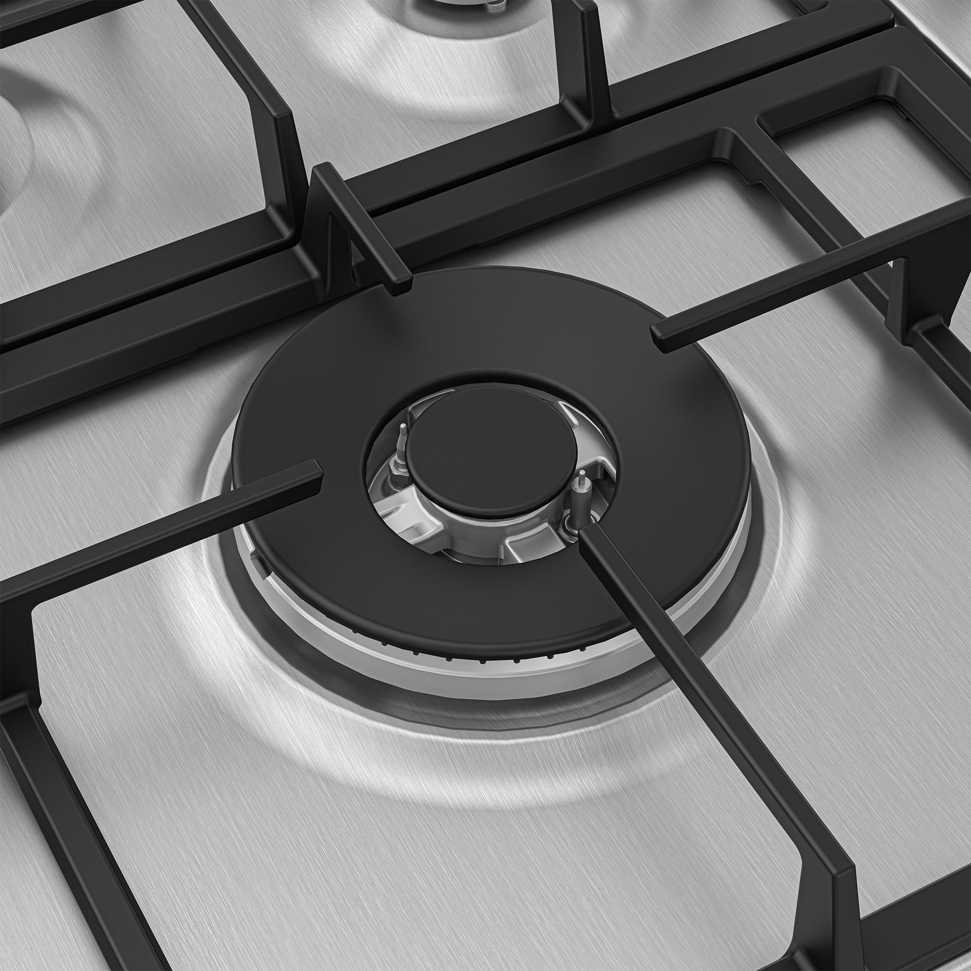 Zbliżenie płyty gazowej. Widoczny palnik i metalowa powierzchnia. Czarne ruszty podtrzymują garnek.