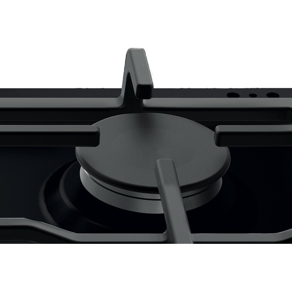 Primer plano de una placa de cocina negra, mostrando el quemador y la rejilla de soporte.
