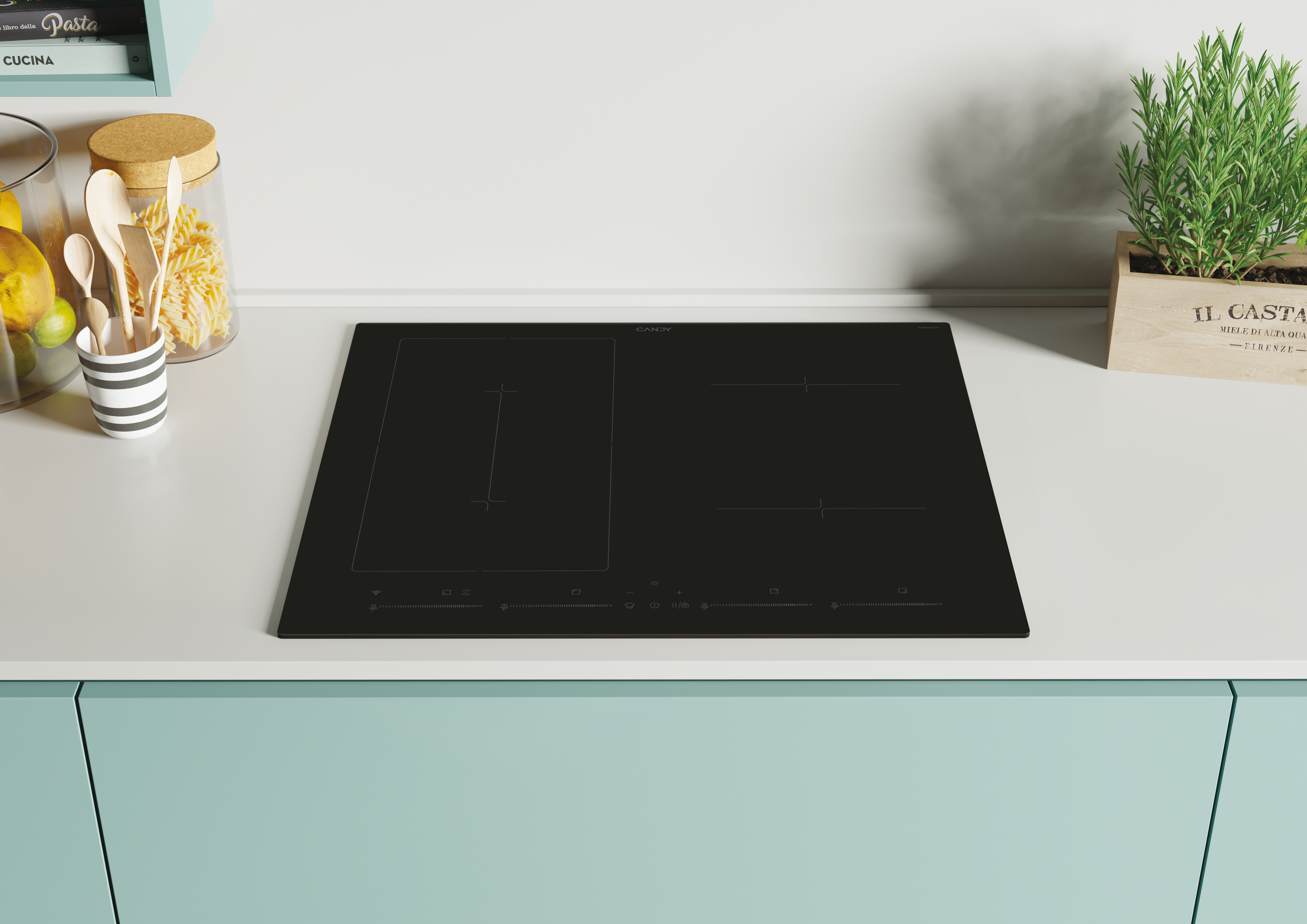 Placa de inducción Candy negra en una encimera, con una planta y utensilios de cocina cerca.