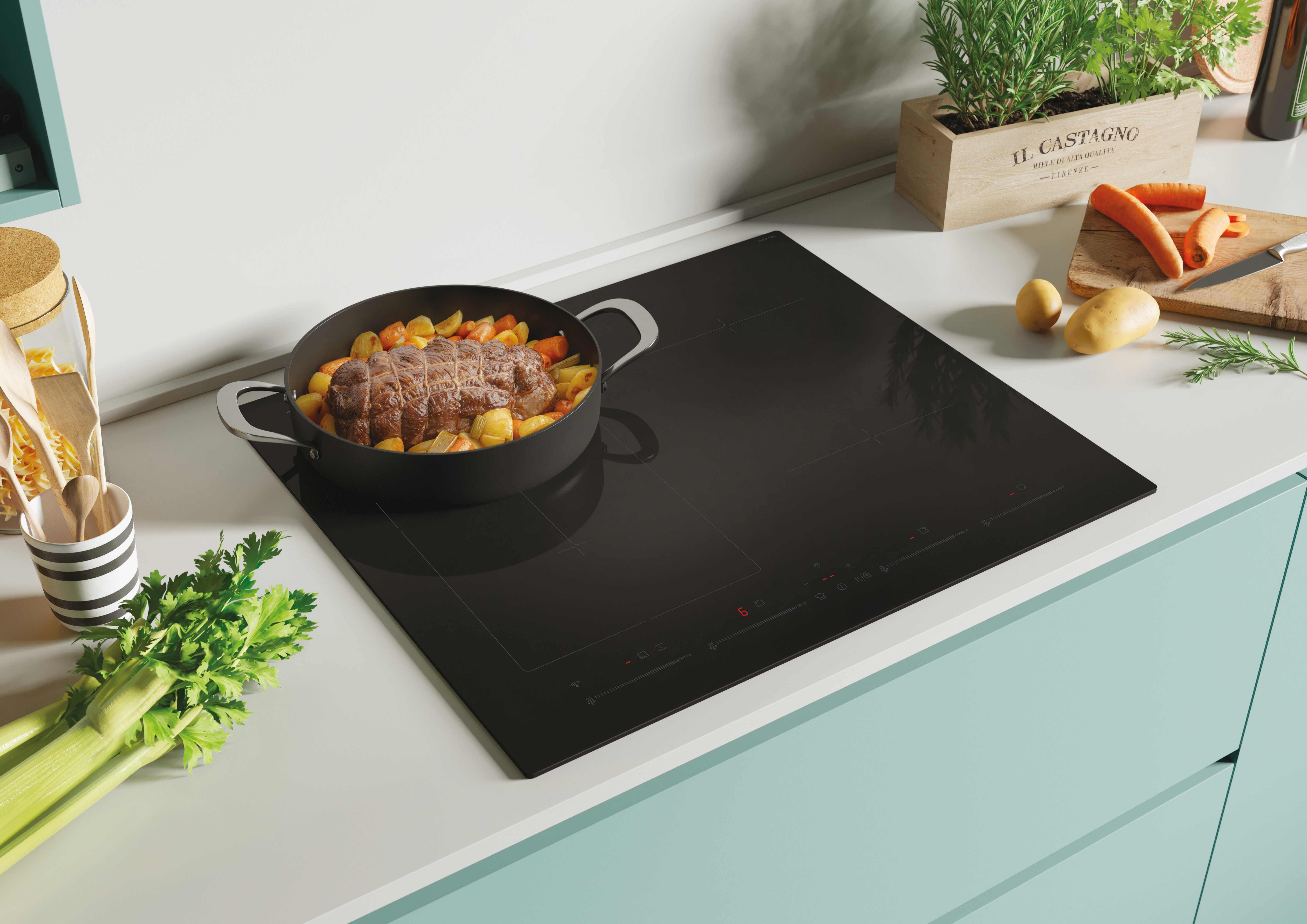 Una placa de inducción negra con una olla de comida, rodeada de ingredientes y utensilios.