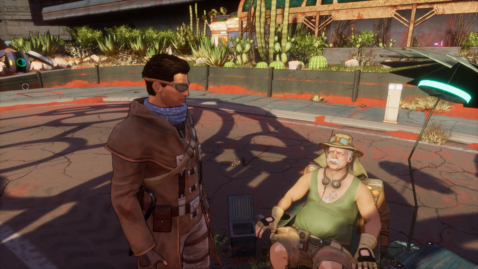 Dwie postacie w okularach przeciwsłonecznych rozmawiają na zewnątrz pod parasolem.