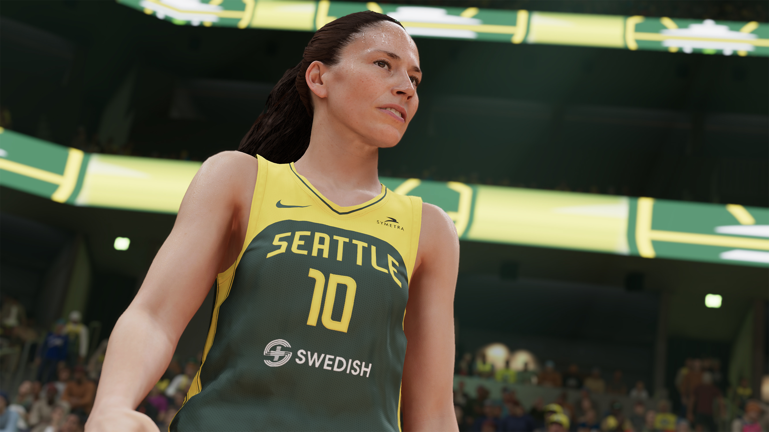 Una giocatrice di basket con una maglia verde di Seattle guarda in alto. La parola Seattle è sulla maglia.