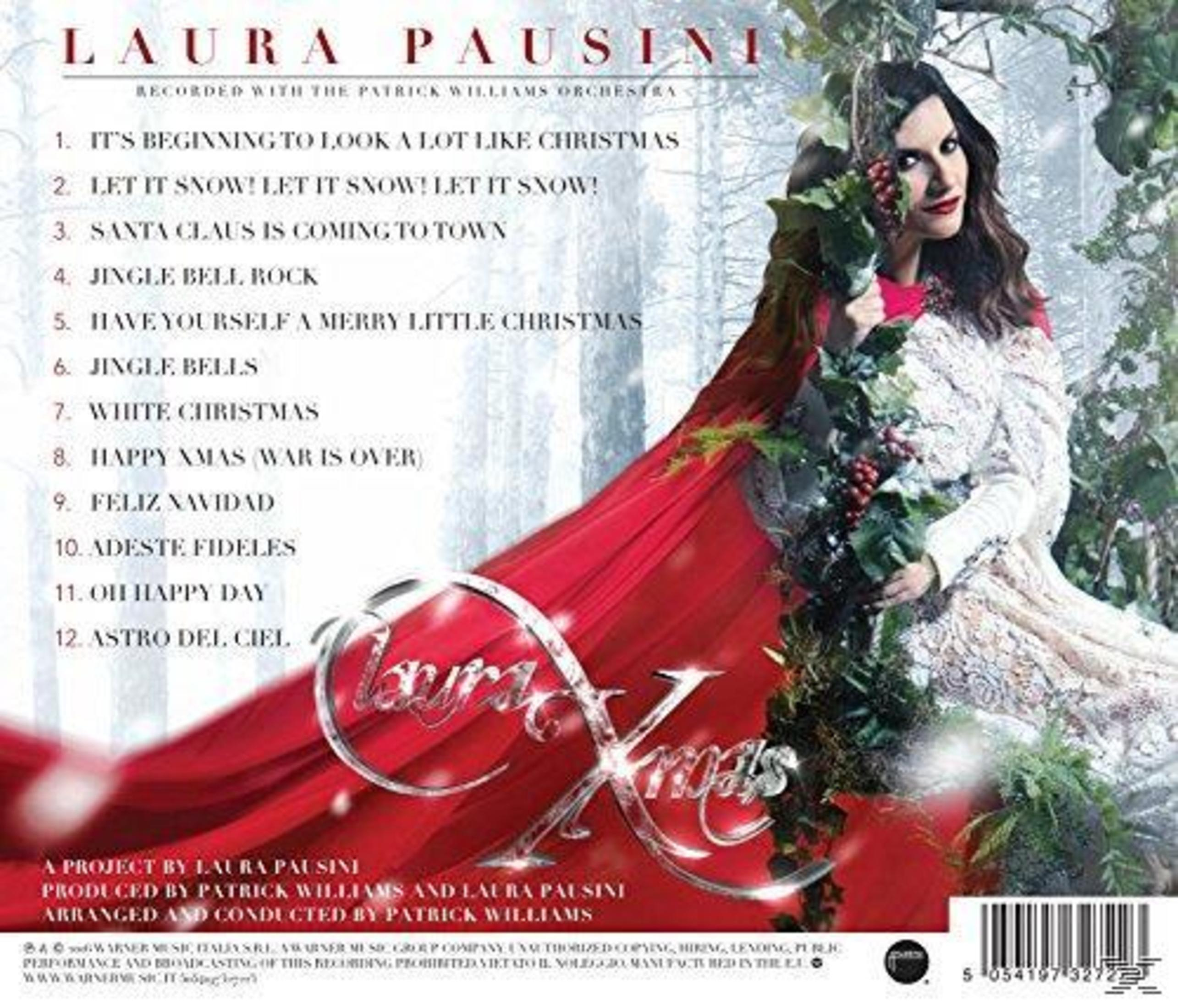 Albumcover mit Laura Pausini und Weihnachtsthema. Sie hält einen Bund roter Beeren.