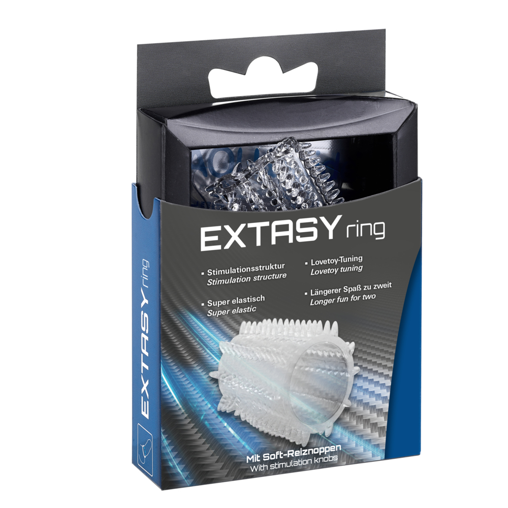 Pierścień do zabaw erotycznych w pudełku. Pierścień jest przezroczysty z teksturowanymi wypukłościami, a na pudełku jest tekst.