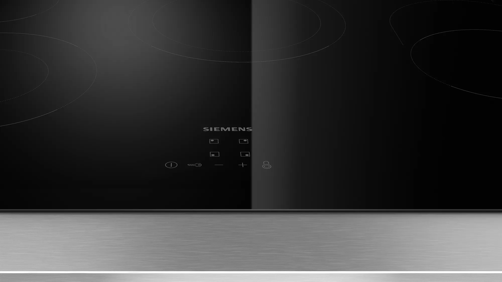 Piano cottura Siemens nero. Comandi touch visibili. Superficie riflettente e minimalista.