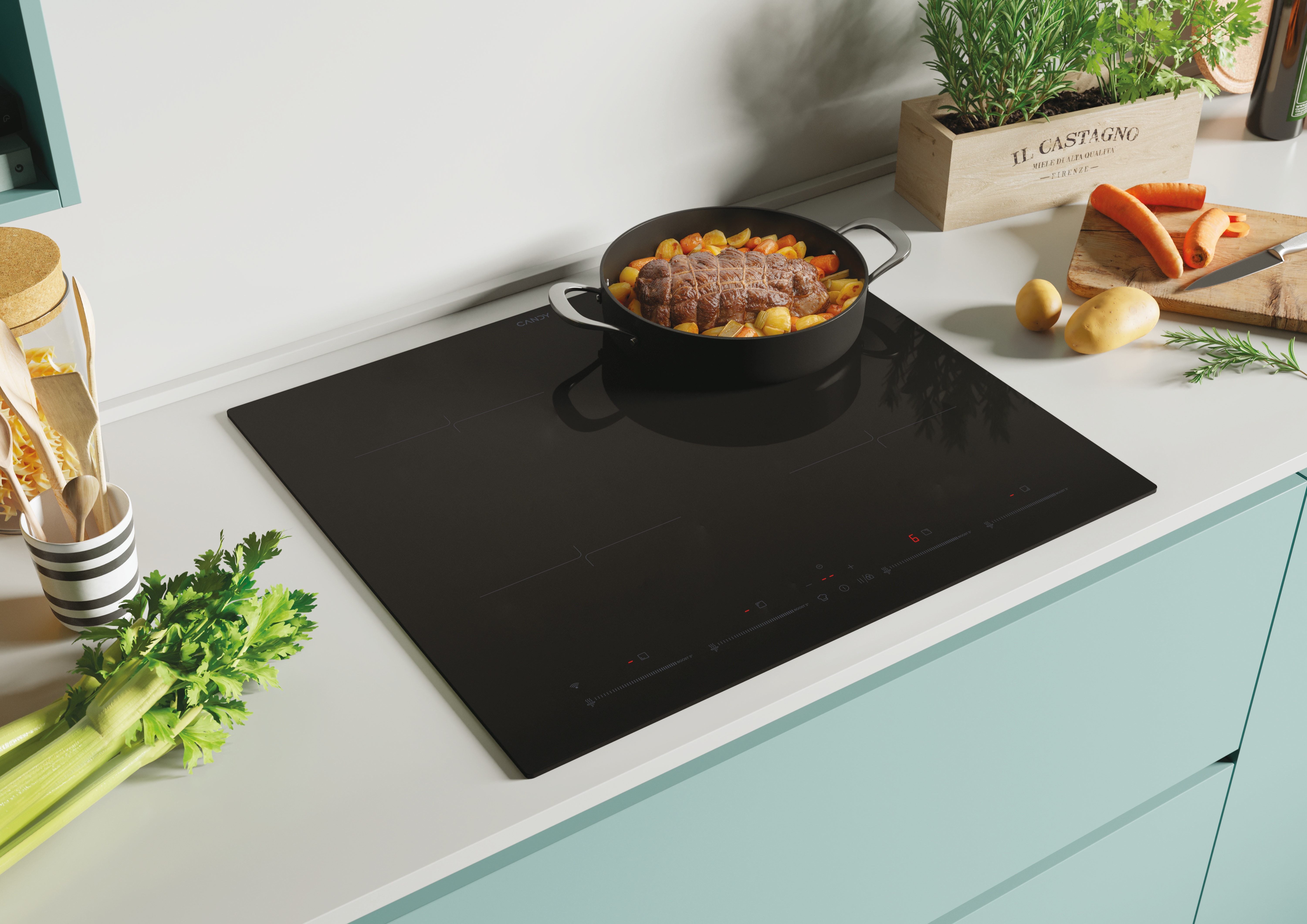 Czarna płyta indukcyjna z jedzeniem. Warzywa, garnek z jedzeniem i marchewki. Miętowy blat.