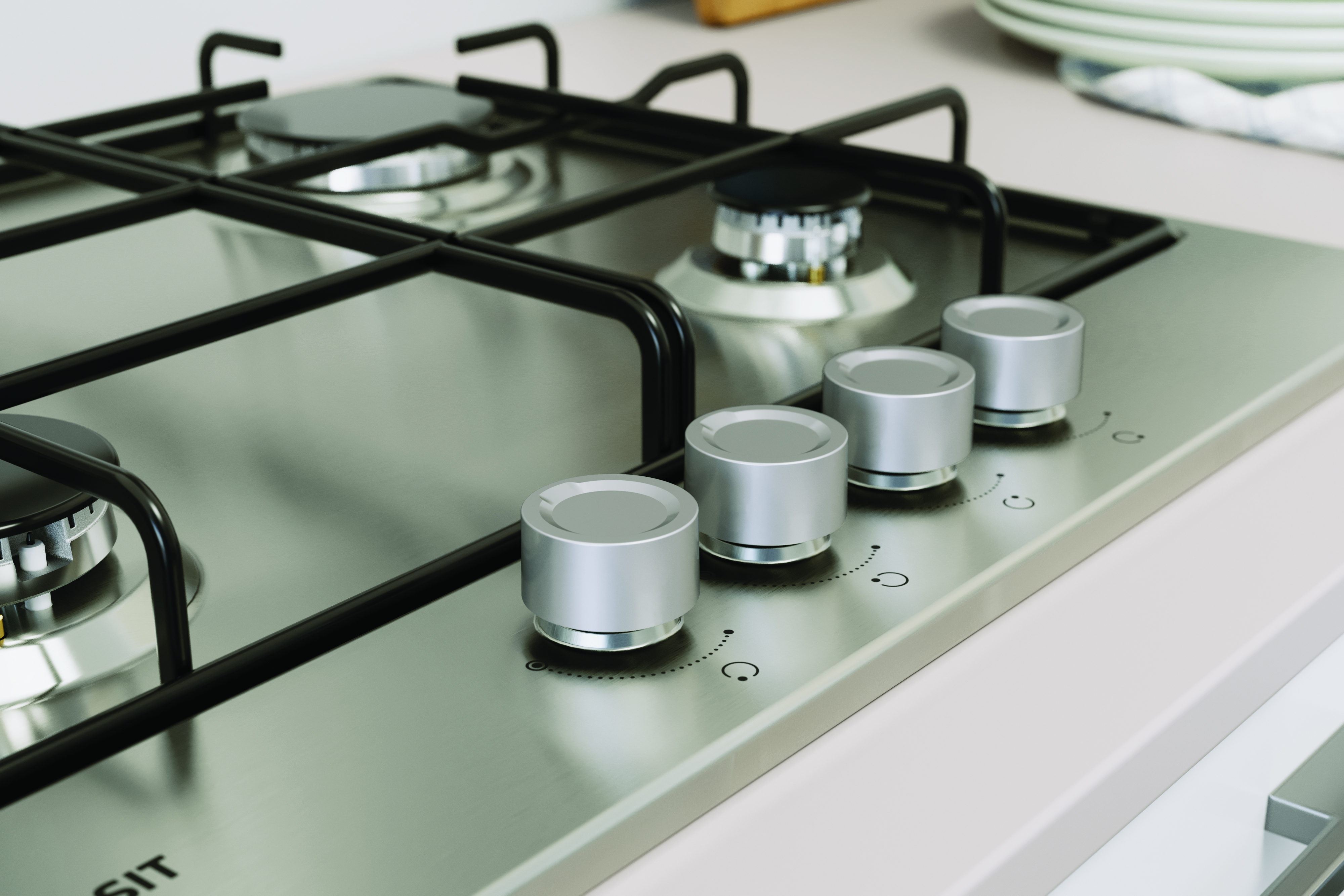 Zbliżenie kuchenki gazowej z czterema srebrnymi pokrętłami i palnikami, powierzchnia ze stali nierdzewnej.