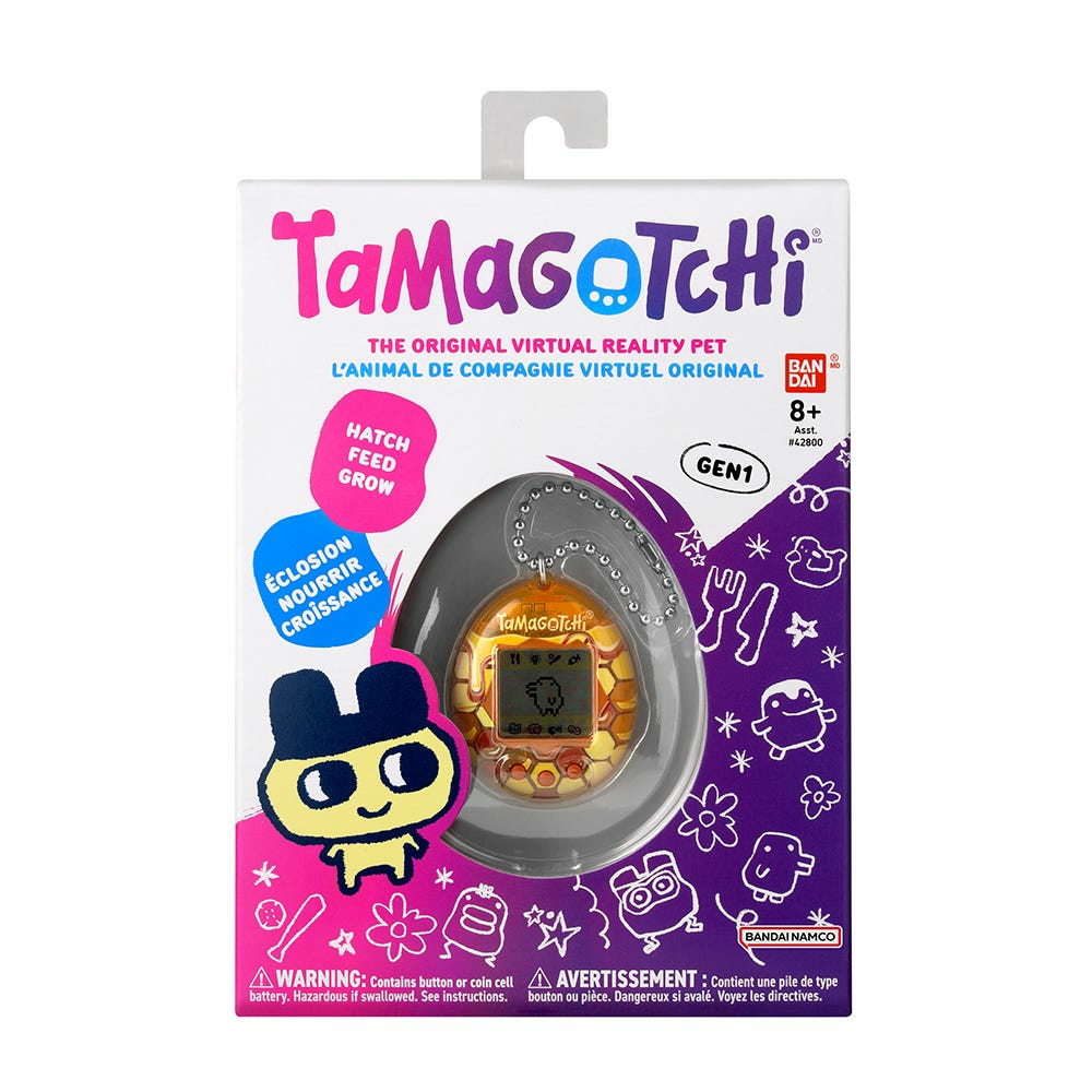 Pudełko z zabawkami Tamagotchi ze zdjęciem wirtualnego zwierzaka.