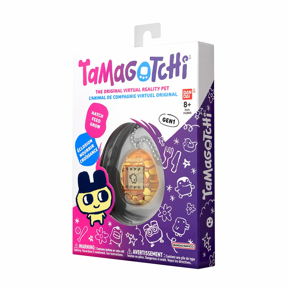 Pudełko Tamagotchi. Zawiera wirtualne urządzenie dla zwierząt. Kolorowy design. Marka Tamagotchi.