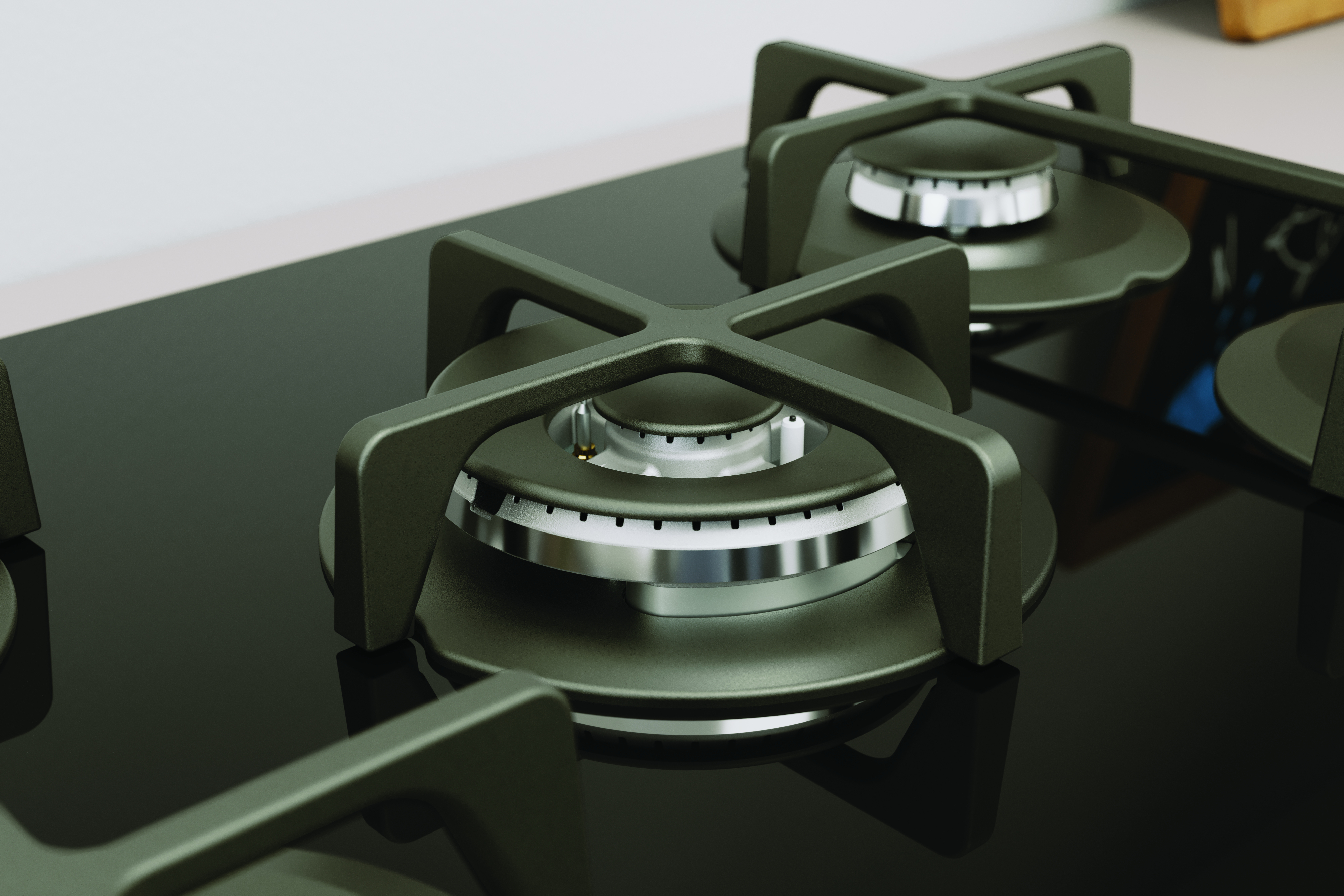 Zbliżenie czarnej płyty gazowej, z palnikami i kratkami, na czarnej powierzchni.