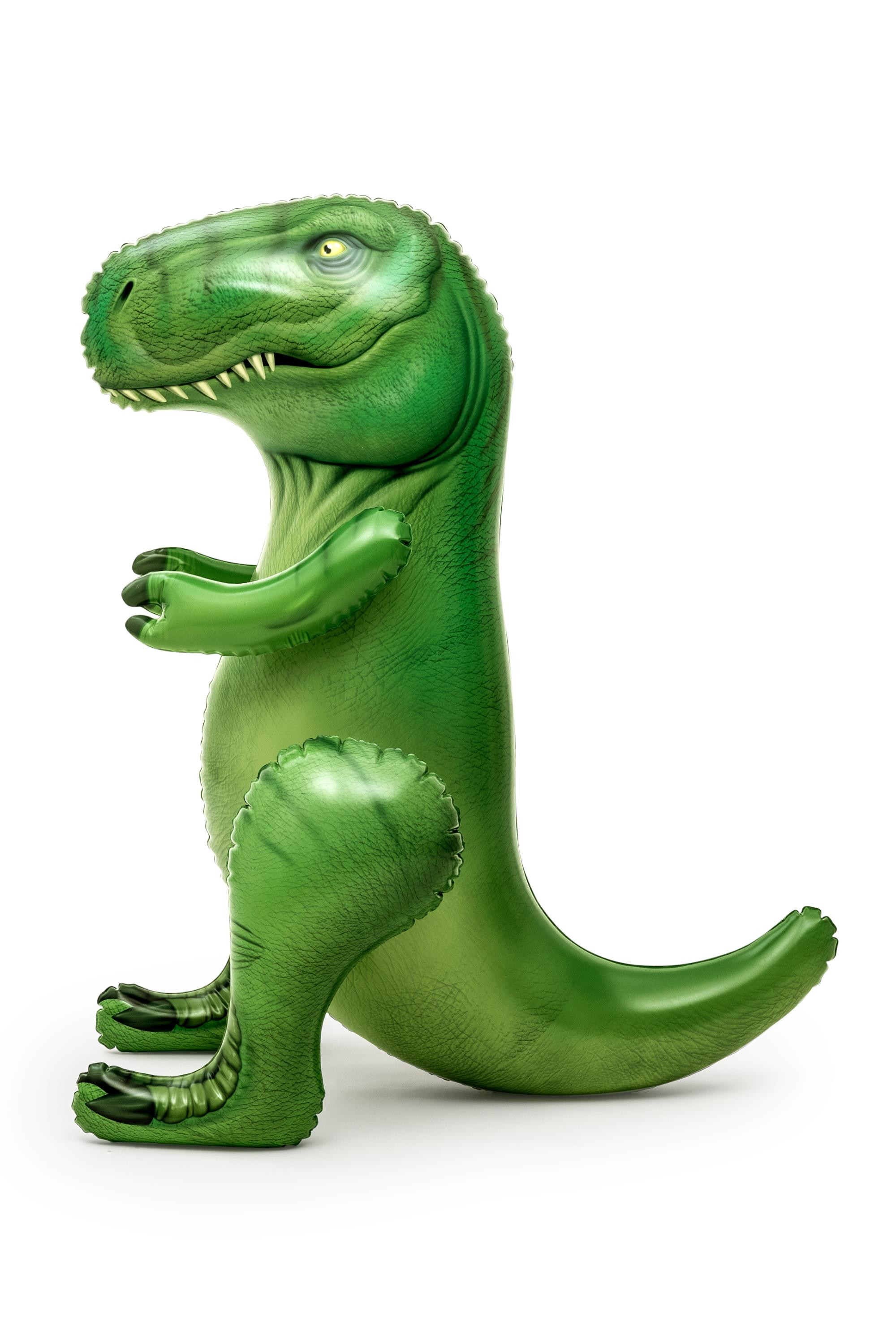 Zielona plastikowa zabawka Tyrannosaurus Rex na białej powierzchni, białe tło.
