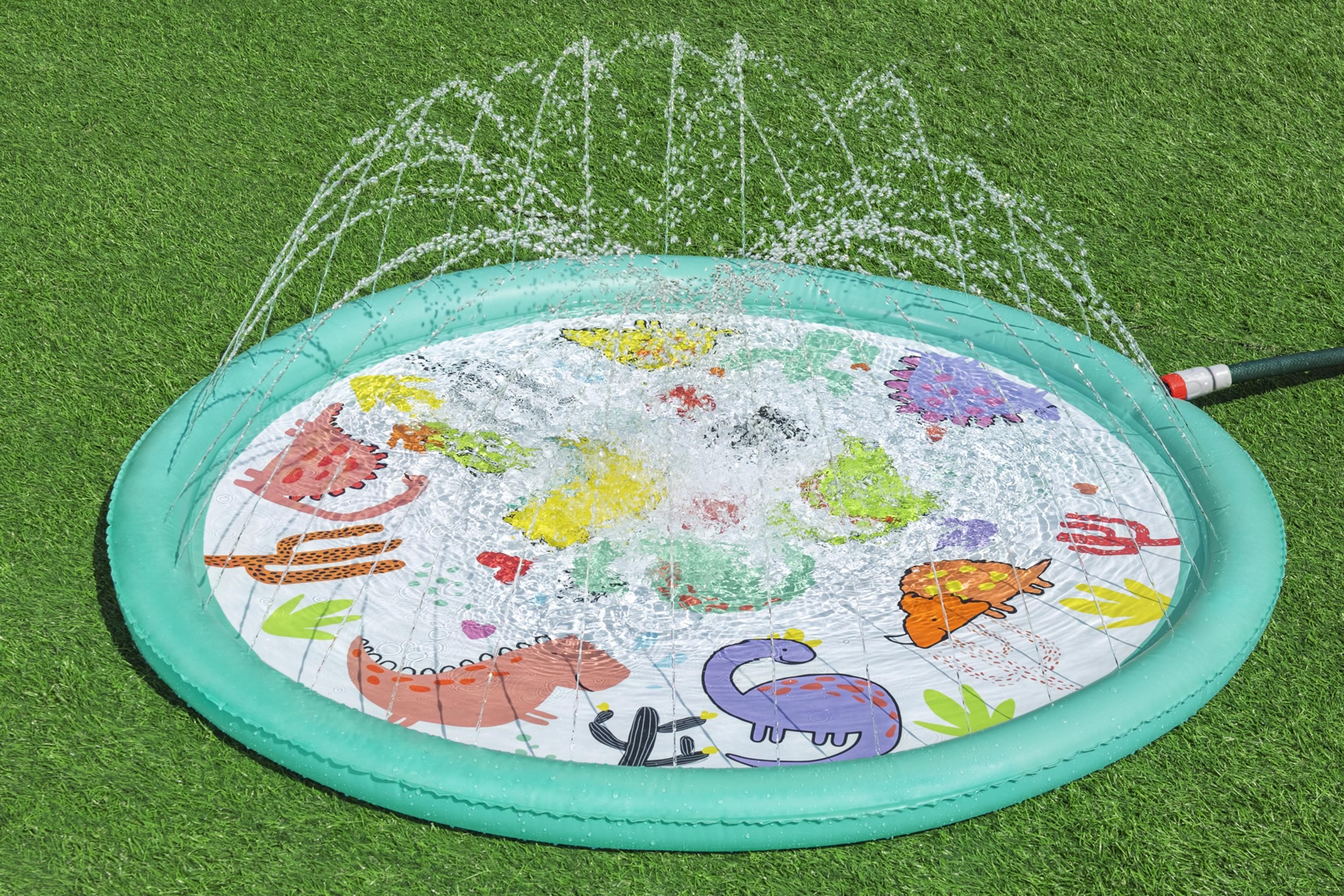 Tappeto gioco, acqua che spruzza. Bordo verde, sfondo bianco con dinosauri.