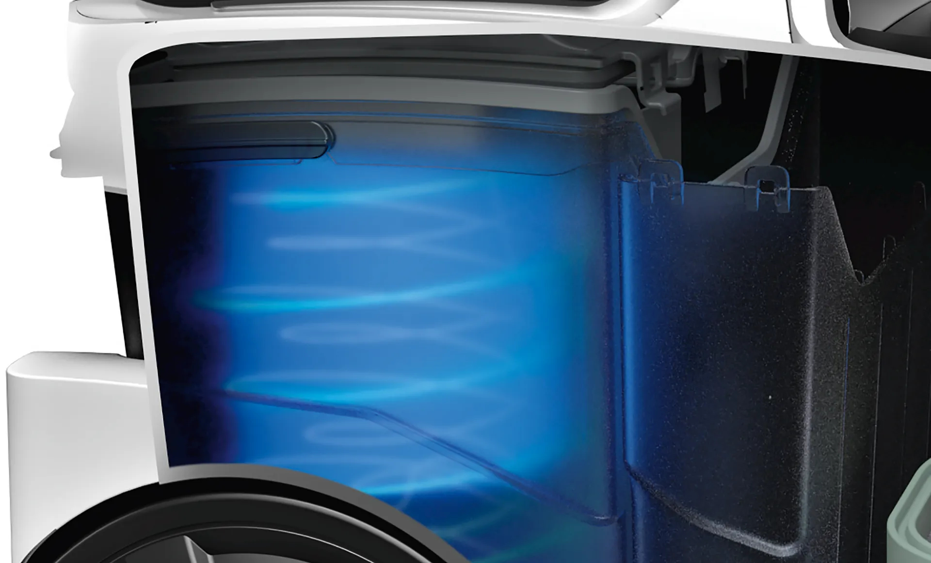 Zbliżenie wnętrza maszyny. Niebieskie, wirujące linie widoczne w komorze. Otaczają białe i czarne części.