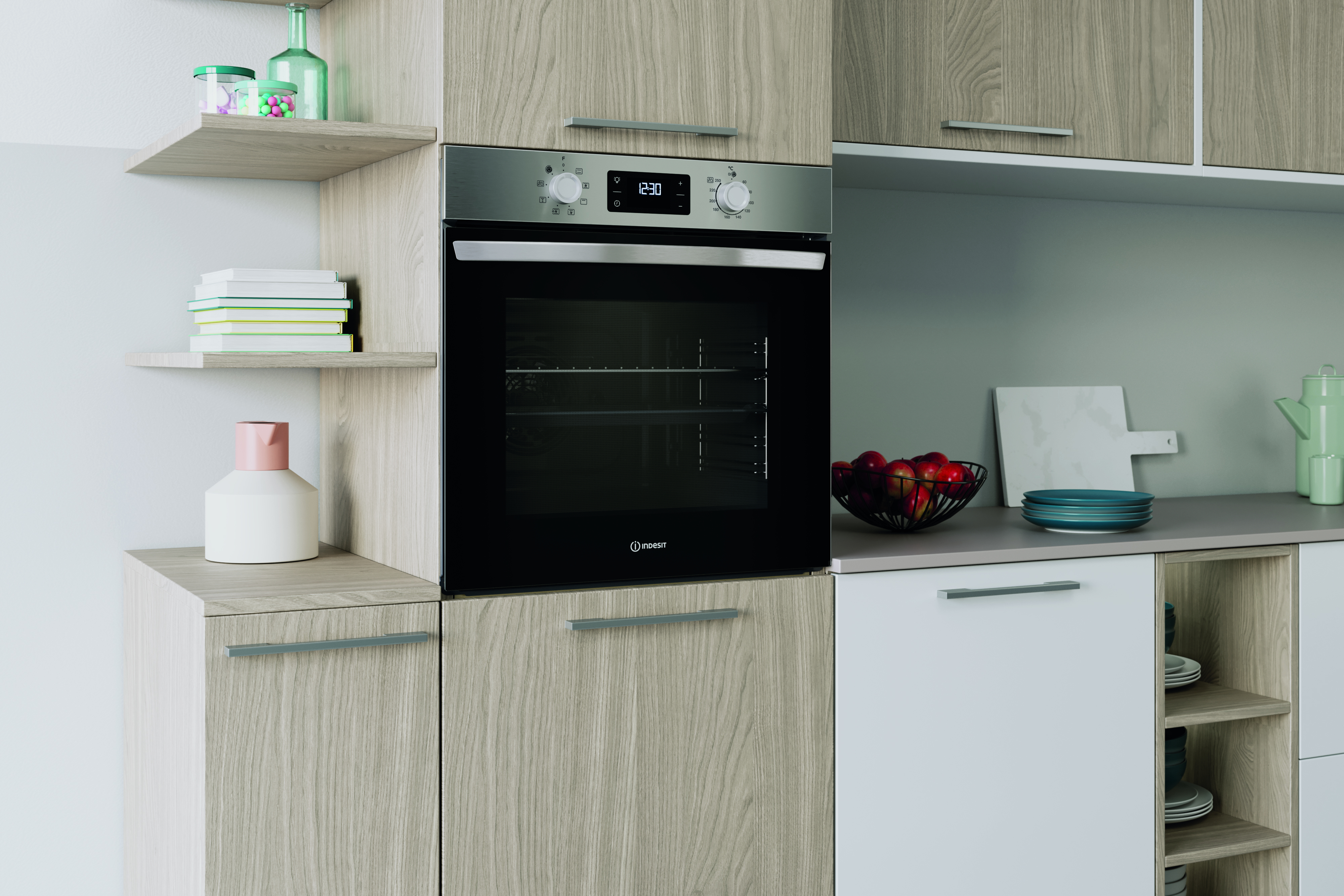 Nowoczesna kuchnia z piekarnikiem, półkami i szafkami. Widoczne owoce i dekoracje.