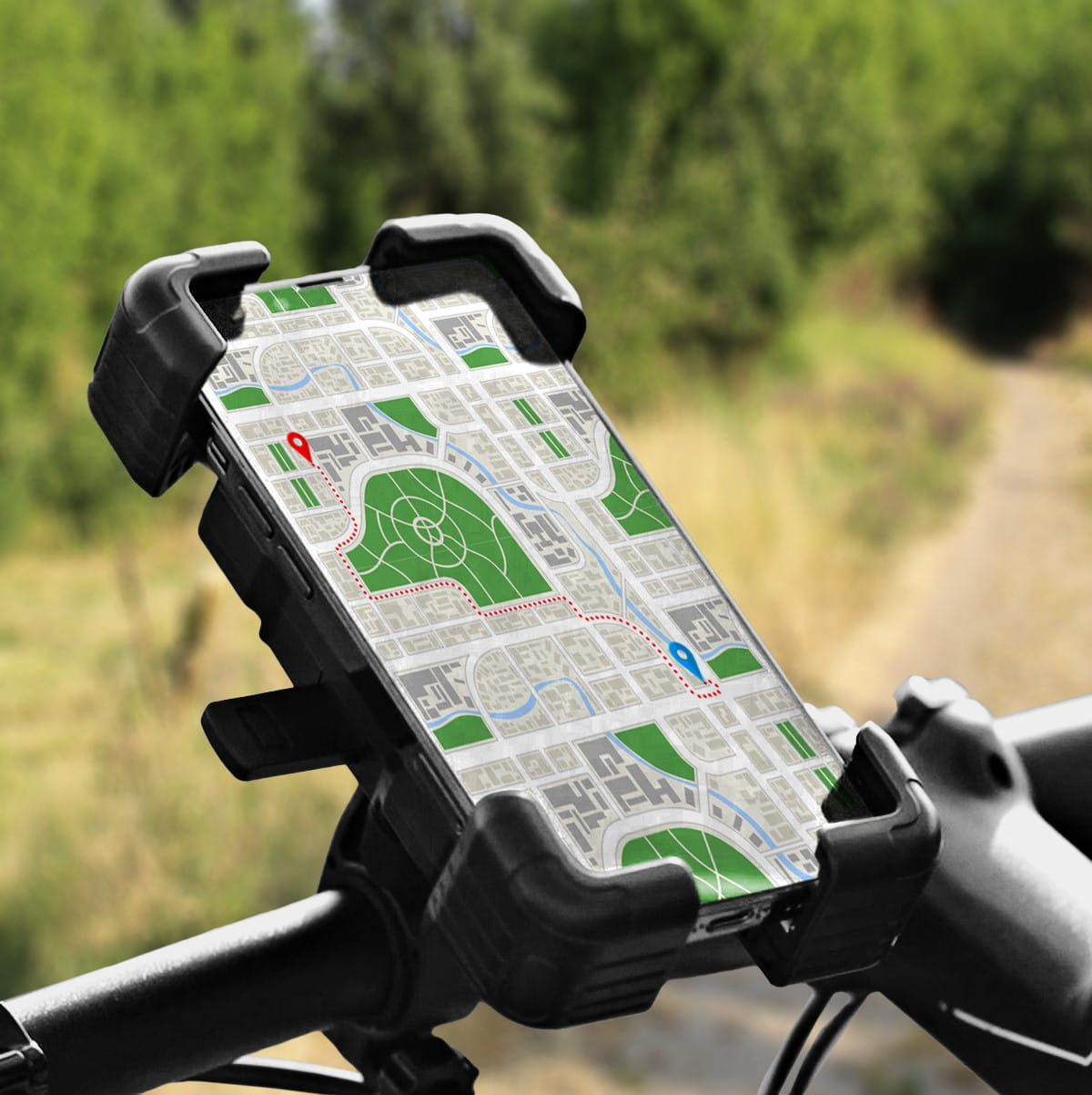 Telefon w czarnym uchwycie na kierownicy roweru pokazuje mapę z trasą i czerwonym i niebieskim pinezką.