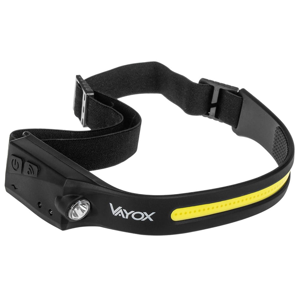 Czarna lampa czołowa z żółtym paskiem i napisem "VAYOX", z przyciskiem i światłem.