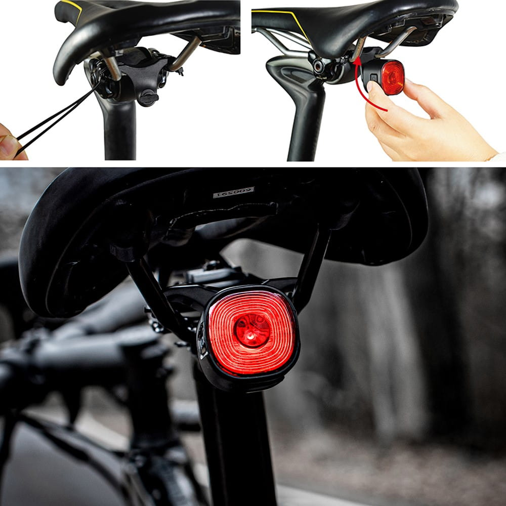 Tylne światło roweru: czarne siodełko, czerwone światło, obsługa ręczna. Tło rozmyte.