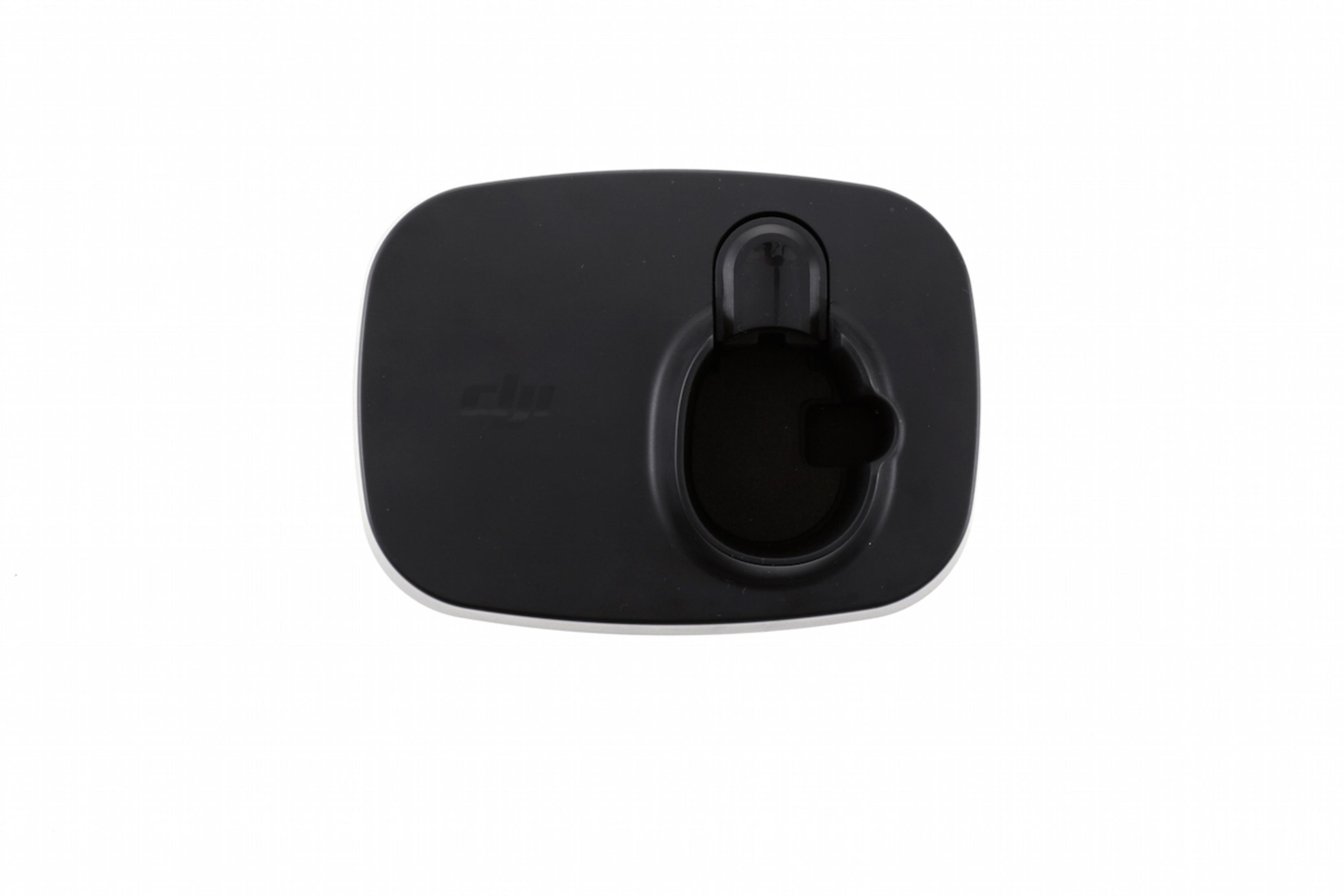 Czarna stacja ładująca dla urządzenia DJI, widok z góry, na białym tle.