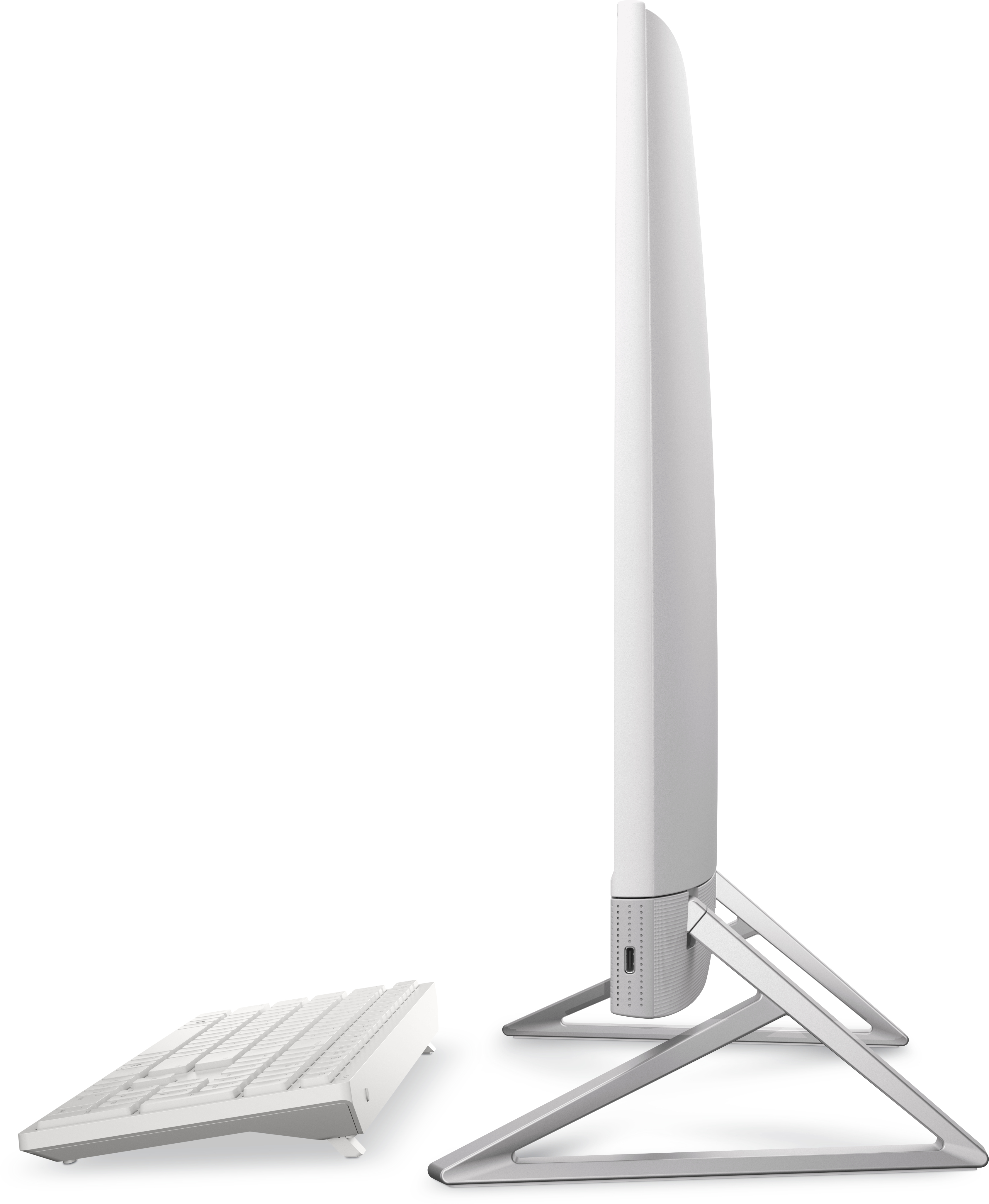 Widok z boku białego komputera Dell. Pokazuje klawiaturę i cienki monitor.