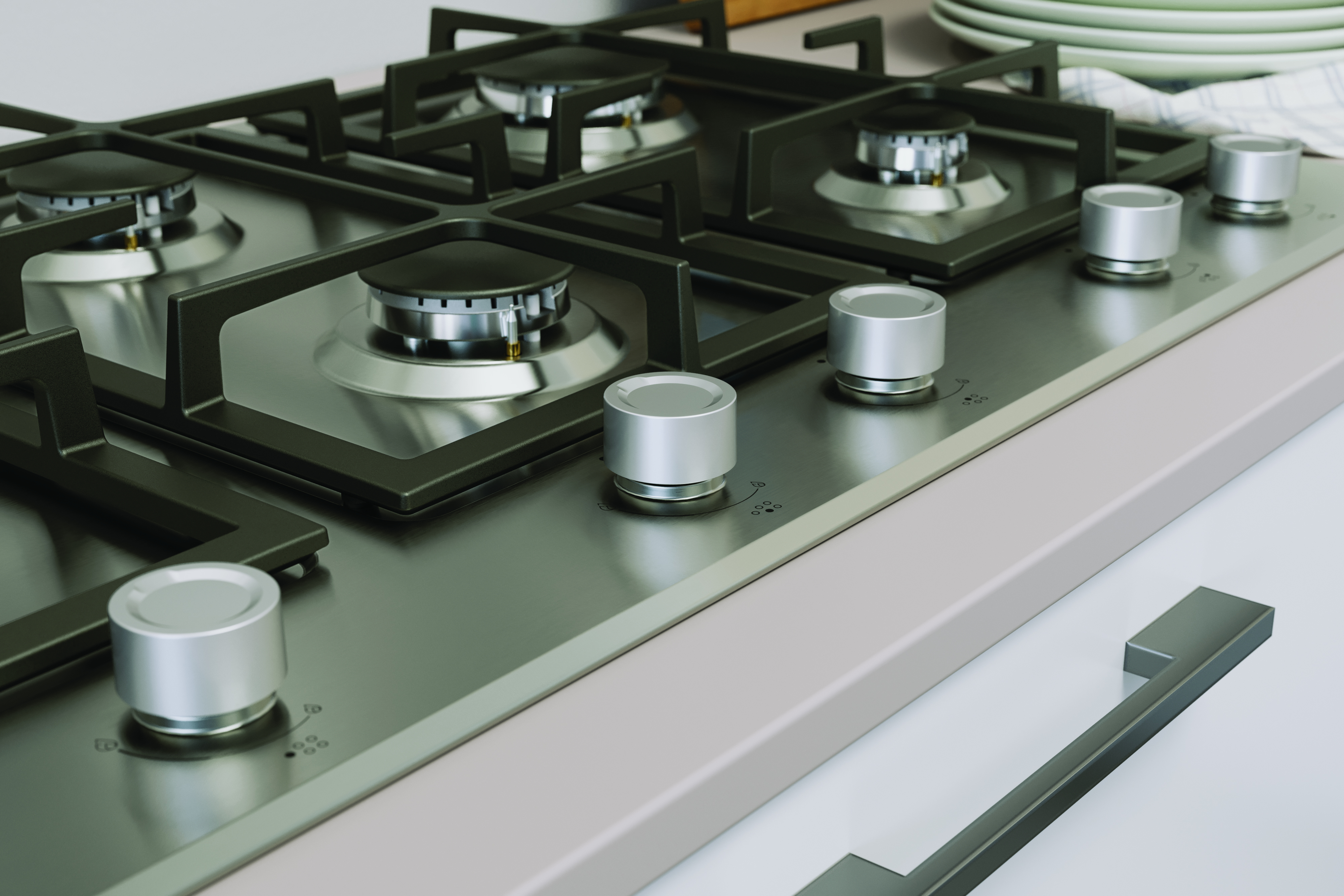 Placa de acero inoxidable con quemadores de gas y mandos. Ambiente de cocina moderno.