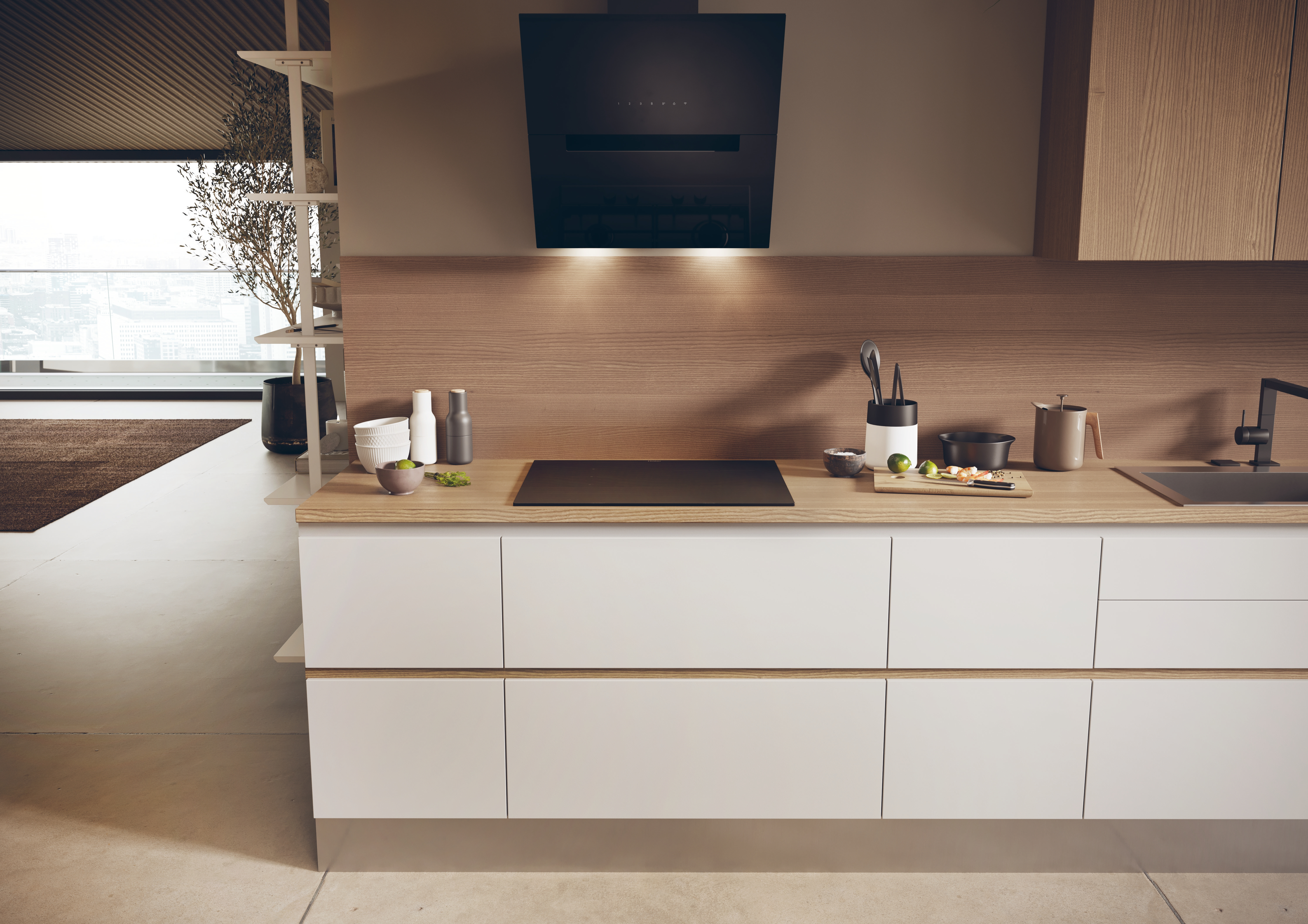 Modern kitchen interior with white cabinets, wooden counter, and a black cooktop.