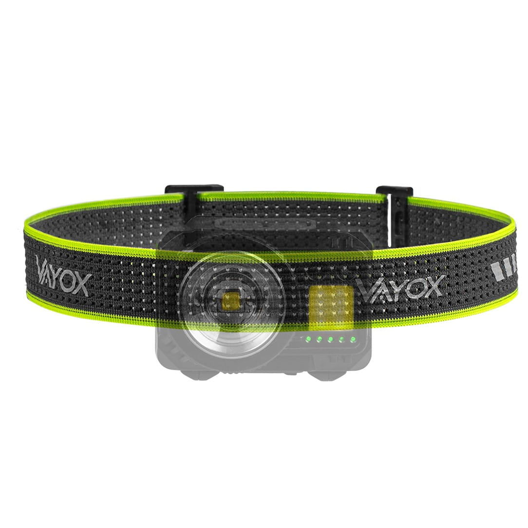 Latarka czołowa na czarnym i neonowo-zielonym pasku. Światło to mała, okrągła lampa.