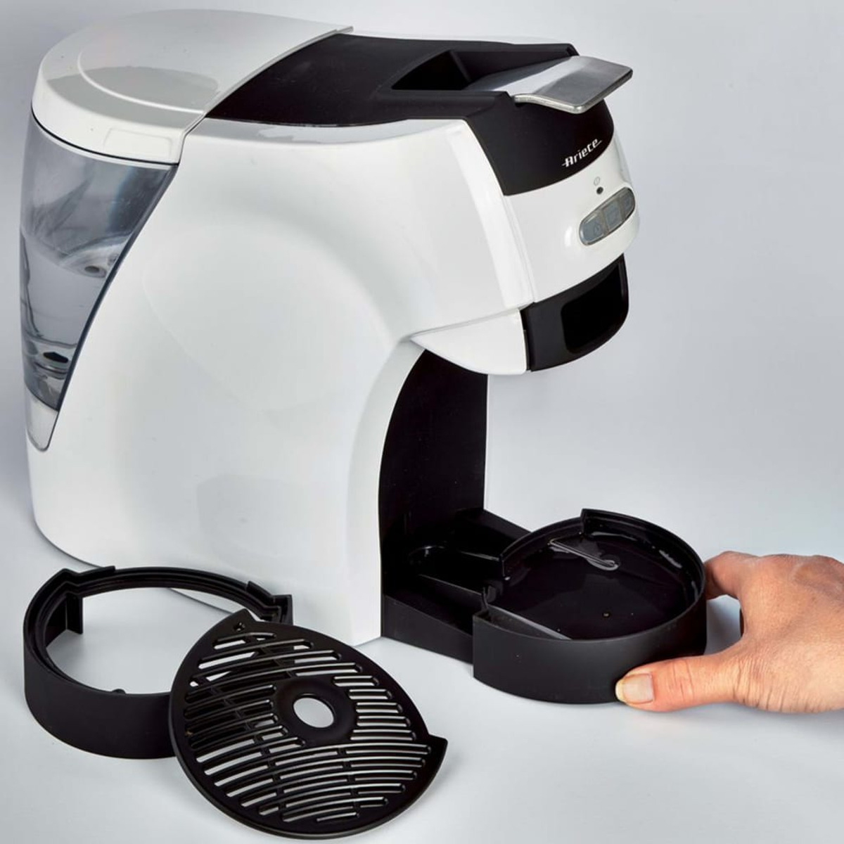 Biało-czarny ekspres do kawy z usuniętymi częściami.