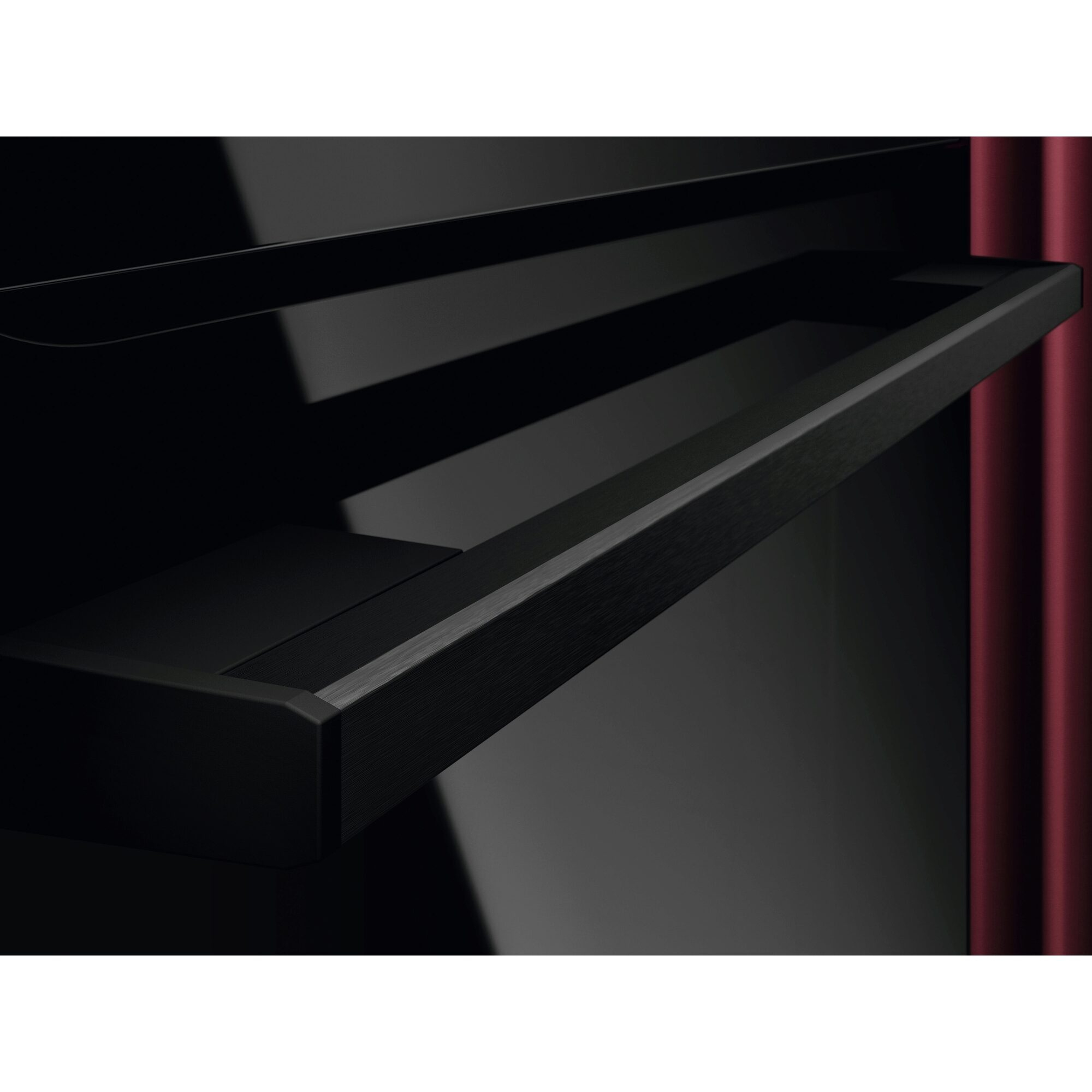 Czarny korpus i półka fortepianu z czerwoną zasłoną po prawej stronie.