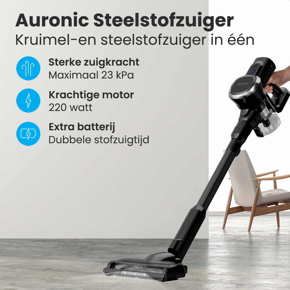 Un aspirateur noir et argenté avec du texte détaillant sa puissance d'aspiration et la puissance du moteur, avec une main.