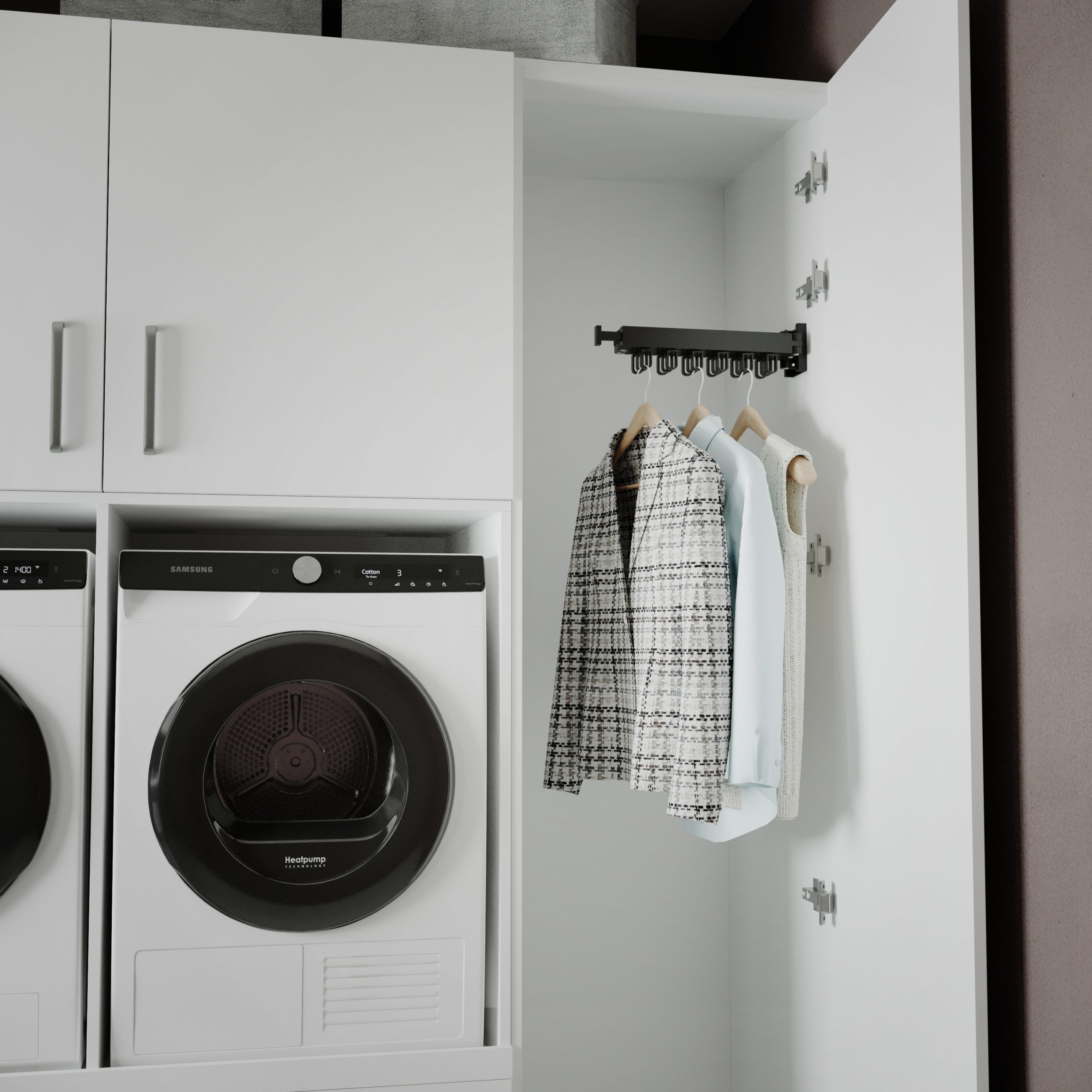 White laundry room with washer, dryer, and hanging clothes.