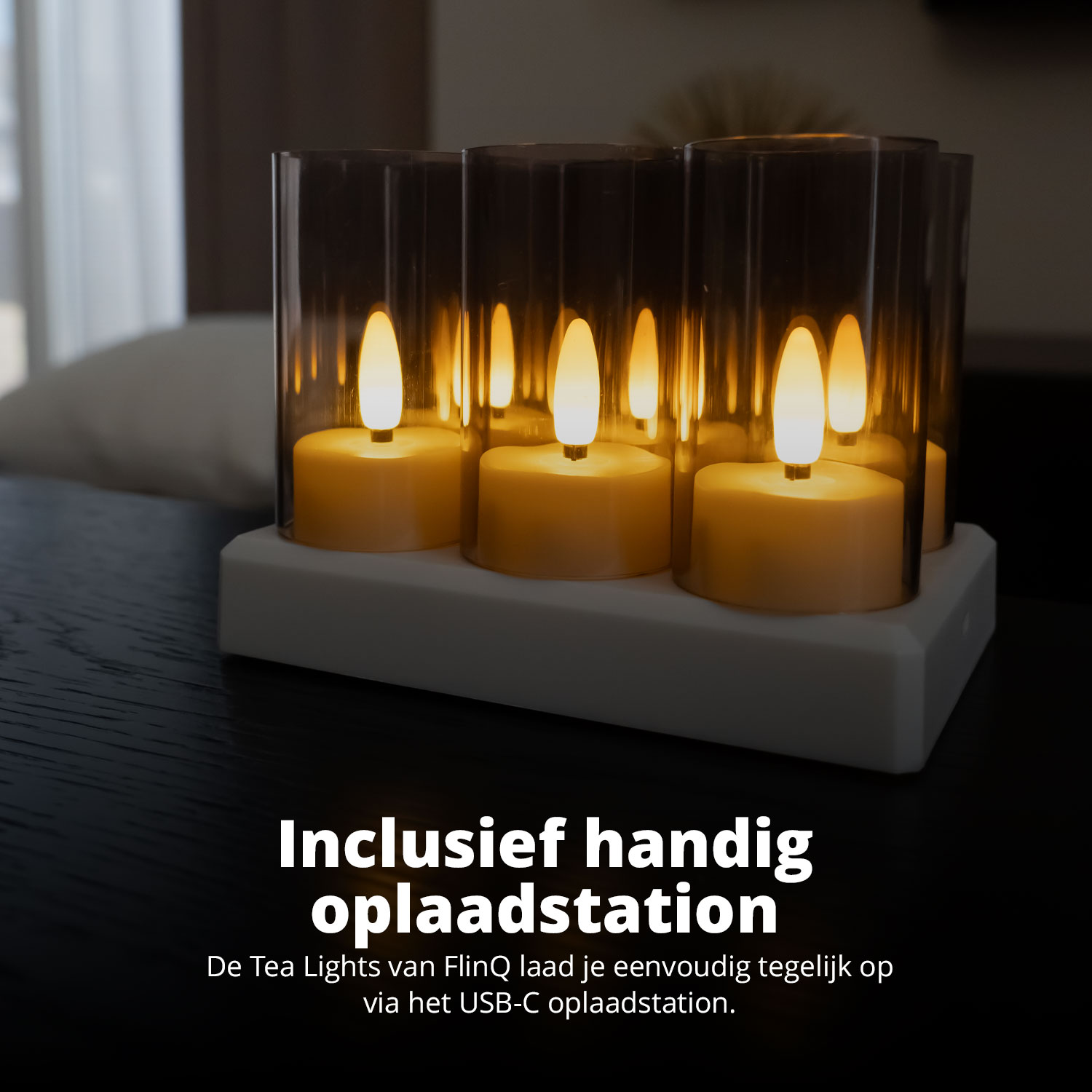 Three lit tea lights in glass holders on a white base. Text says 'Incl. charging station'.