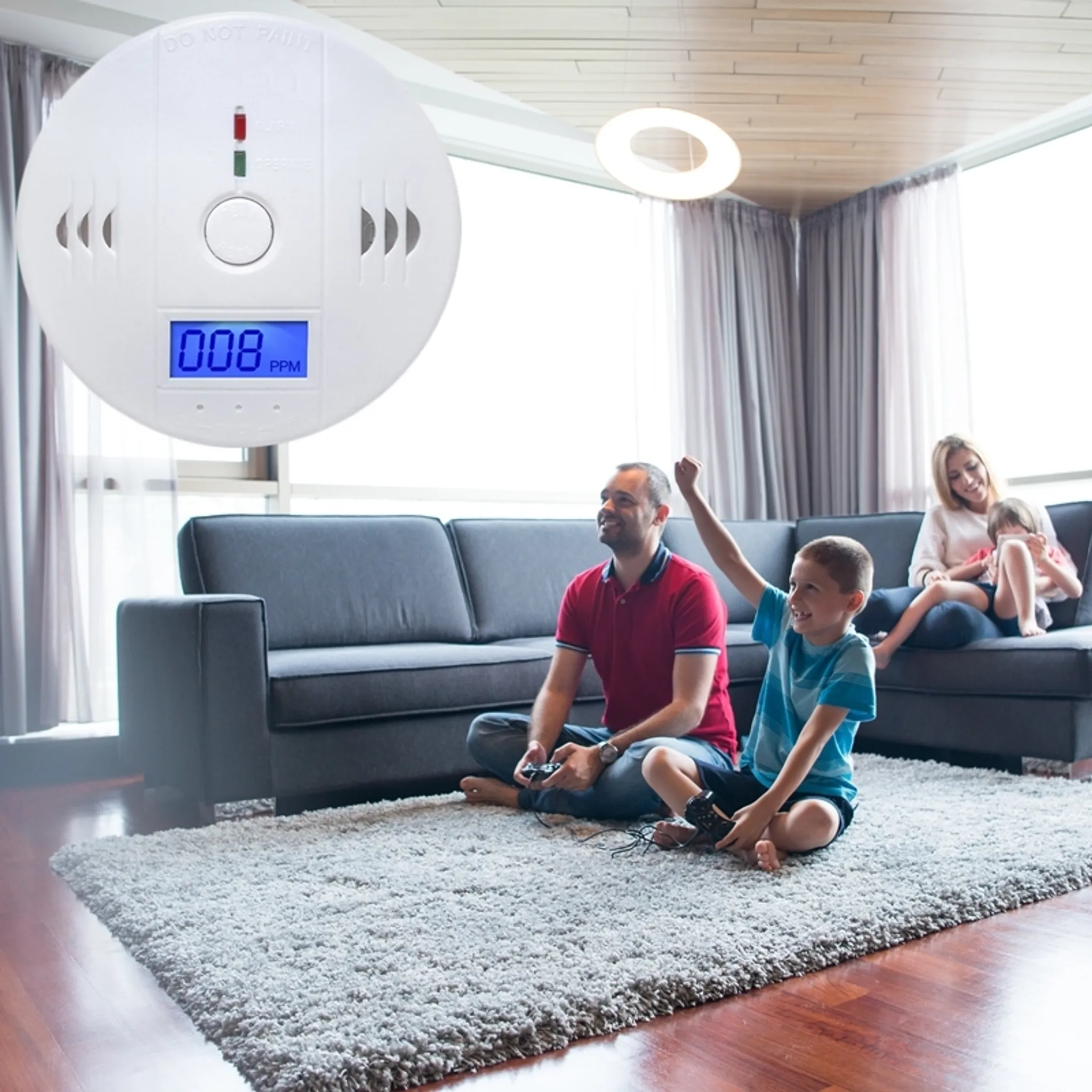 Weißer Rauchmelder zeigt 008 PPM an. Familie spielt Spiele im Wohnzimmer. Ein beleuchteter Kreis.