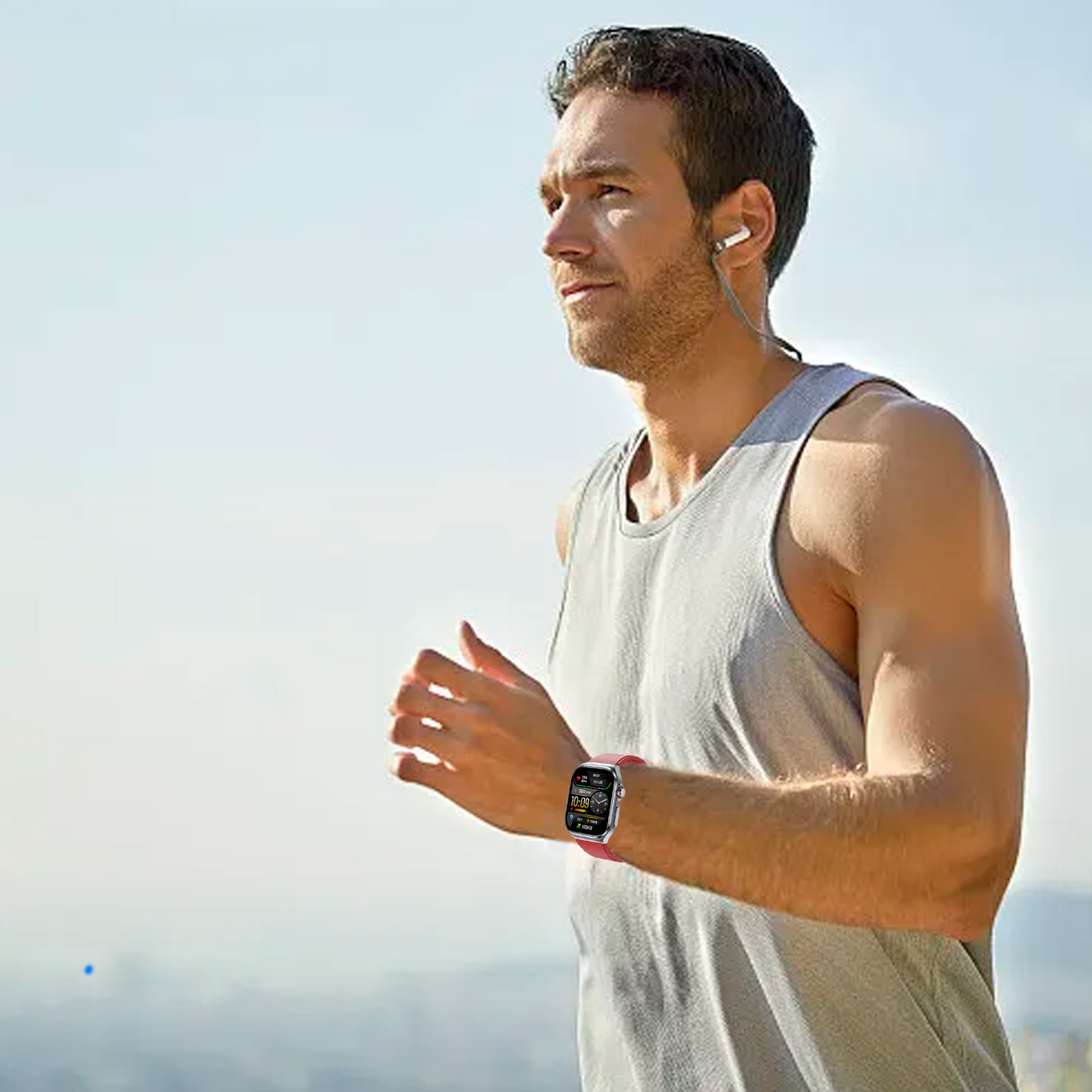 Ein Mann, der mit einer Smartwatch am Handgelenk läuft und ein graues Tanktop trägt.