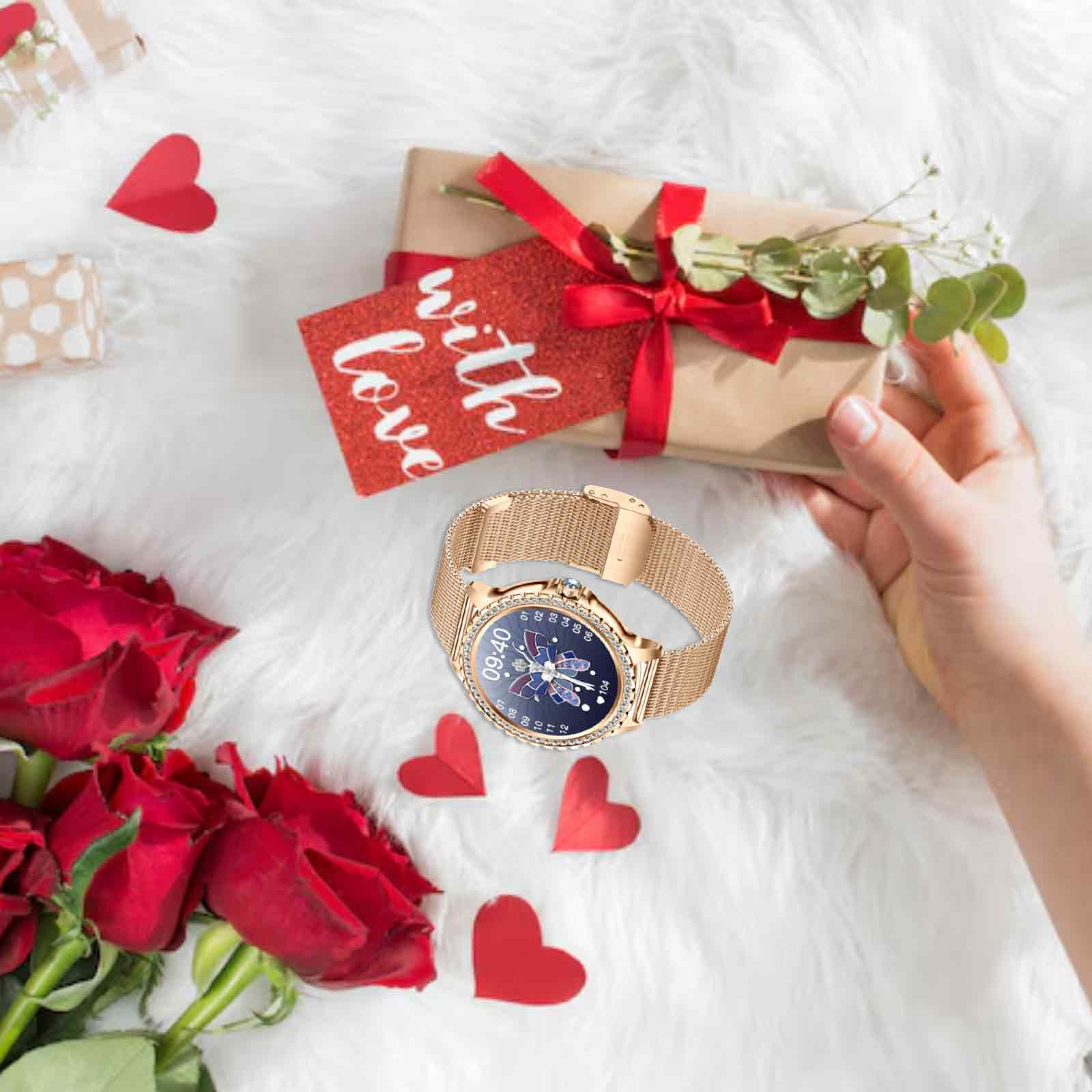 Eine goldene Smartwatch mit goldenem Armband und eine rote Geschenkkarte mit Schleife und roten Herzen.