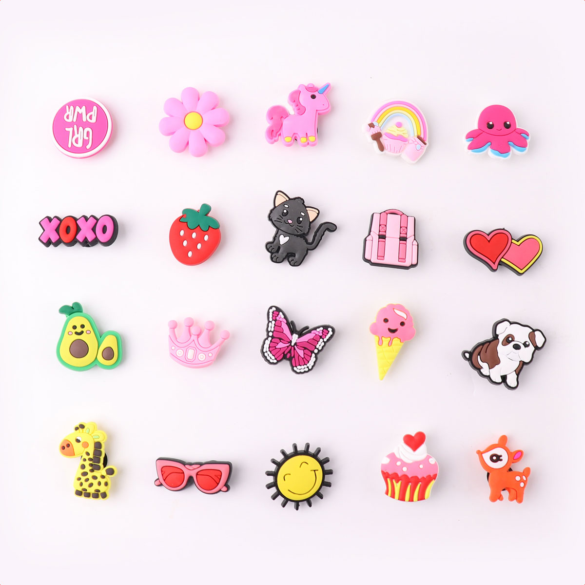 A collection of colorful charms. There is a flower, cat, butterfly, and other fun shapes.