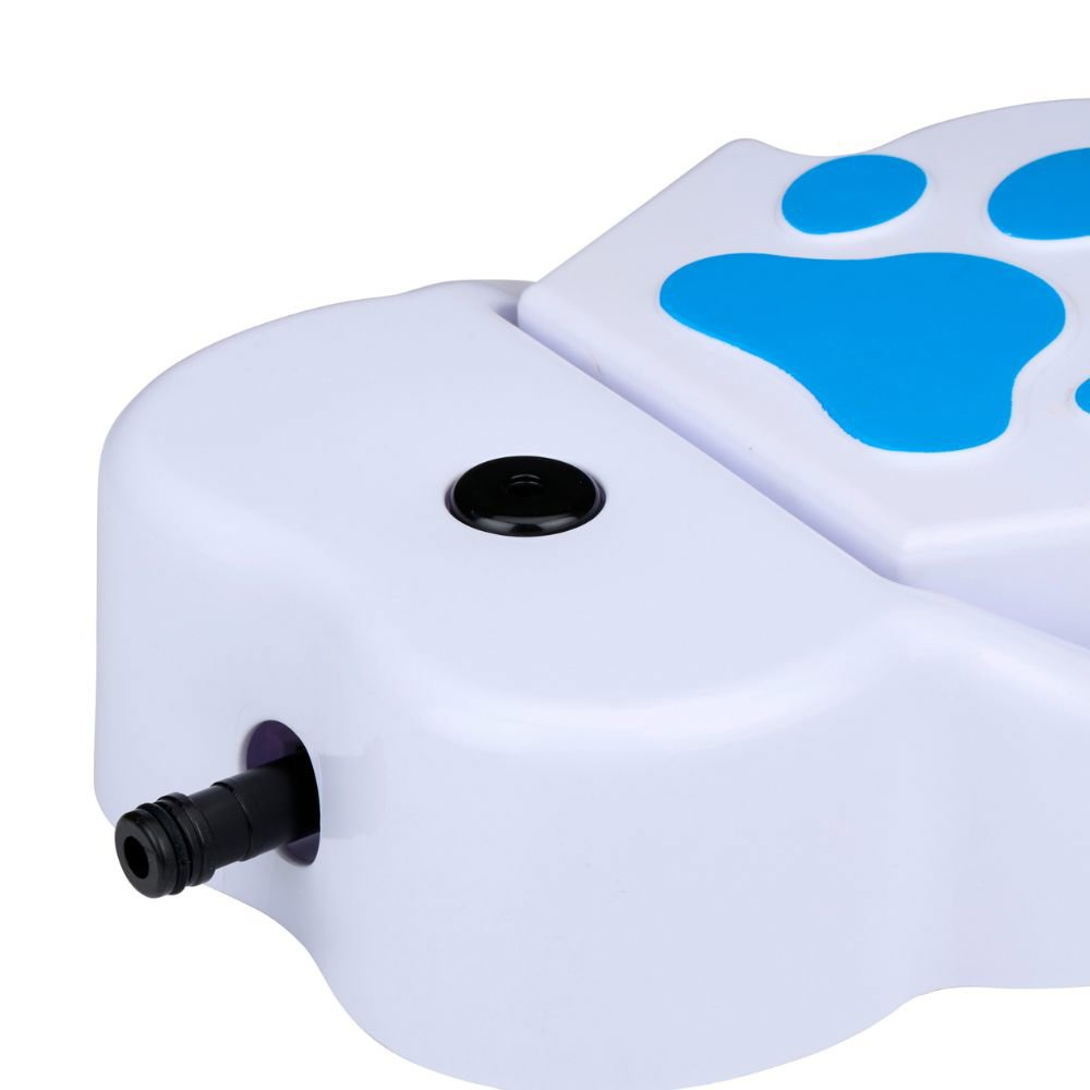 Close-up of a white dog paw shaped water dispenser with blue paw prints on top.