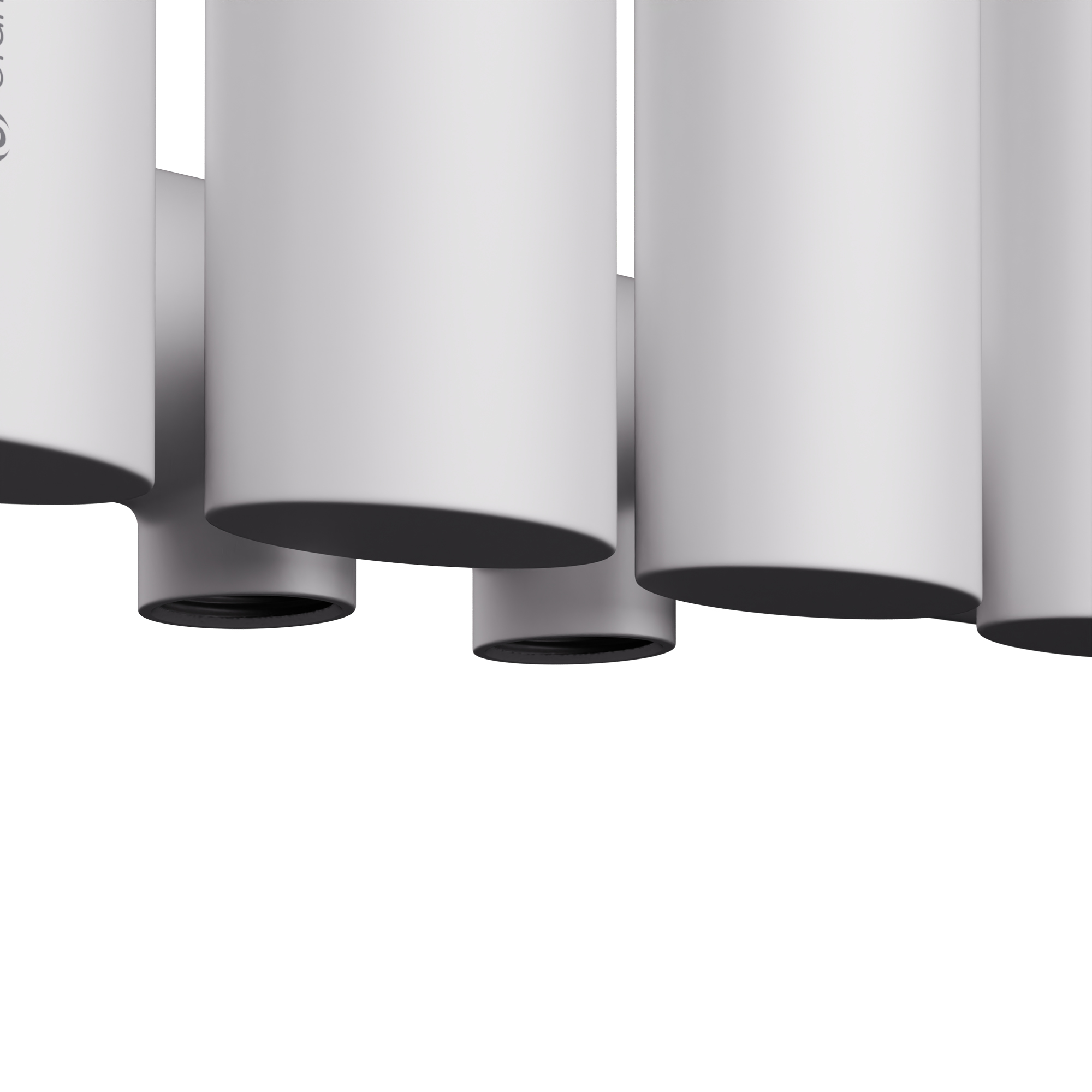 Primer plano de tubos de radiador blancos, con conexiones negras. Vista desde abajo.