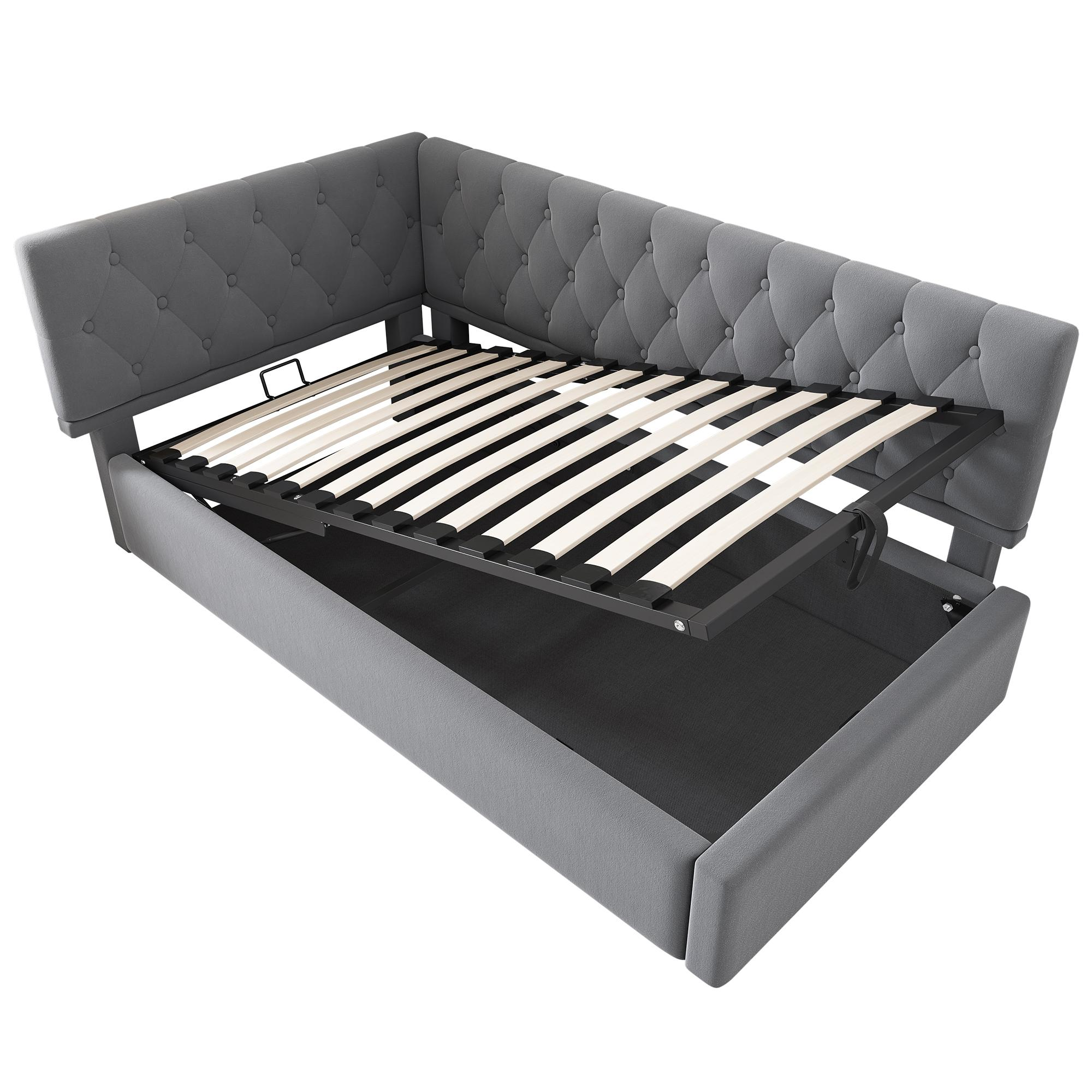 Ein graues L-förmiges Bett mit Stauraum. Die Matratzenbasis ist angehoben, Stauraum sichtbar.