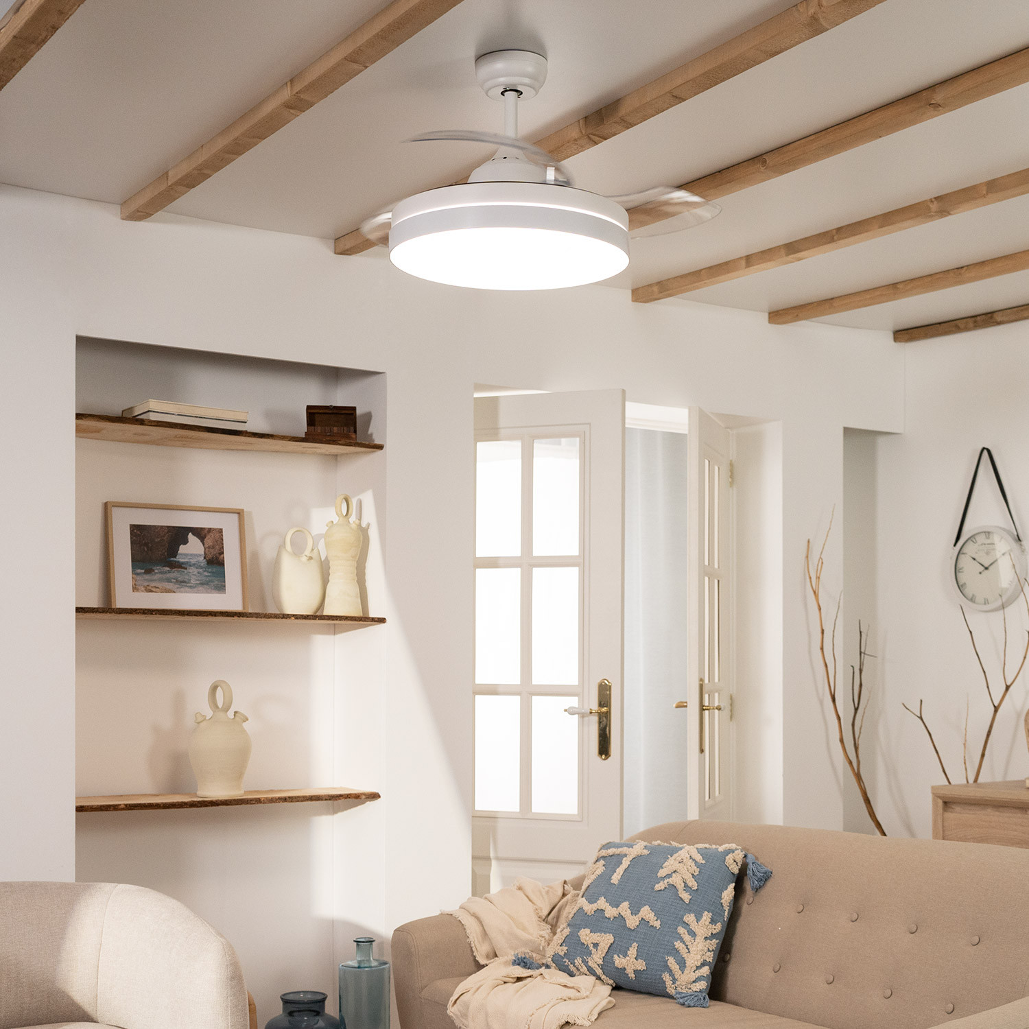 Ventilatore a soffitto bianco con luce, in una stanza bianca. Travi di legno sul soffitto.