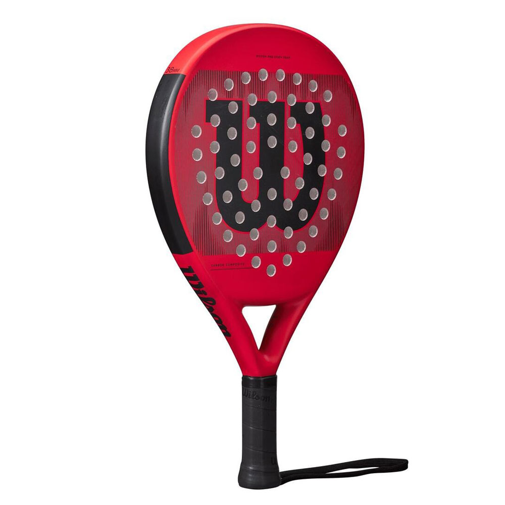 Racchetta da padel Wilson rossa con manico nero. Lo sfondo è bianco.