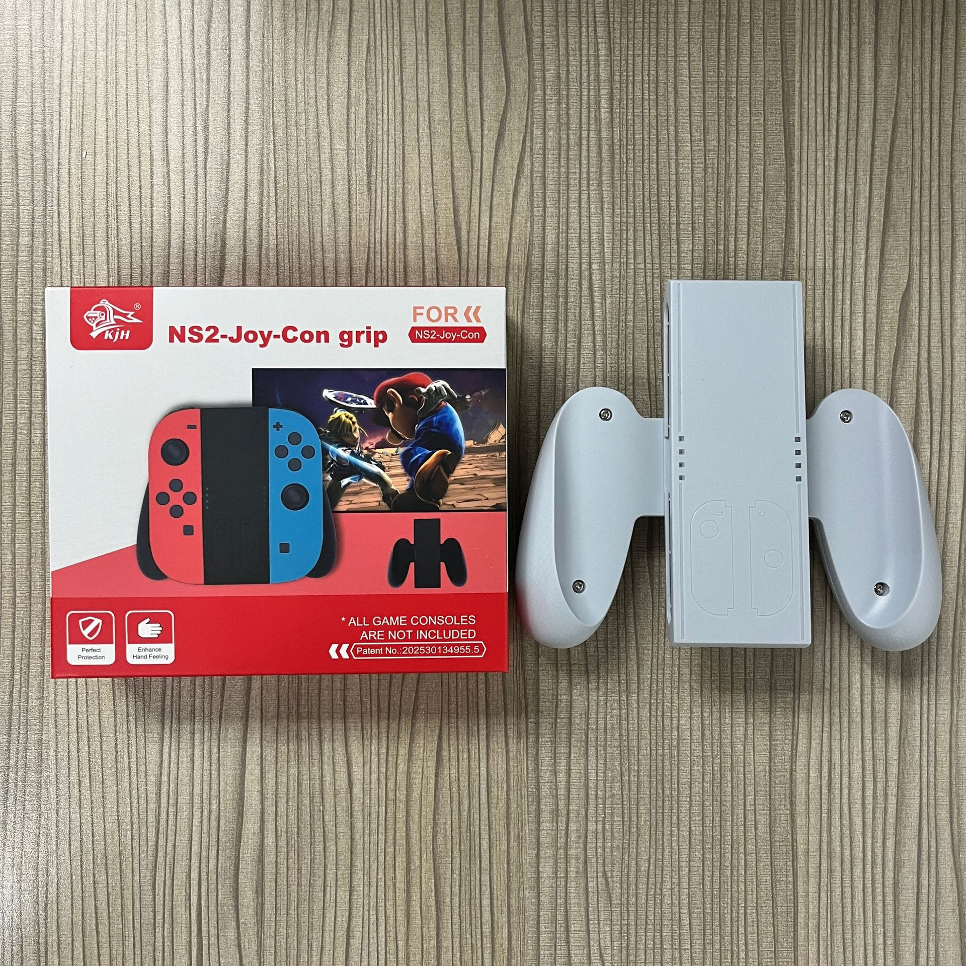 A game controller accessory set with a box showing a game console and characters. The set is on a wooden surface.