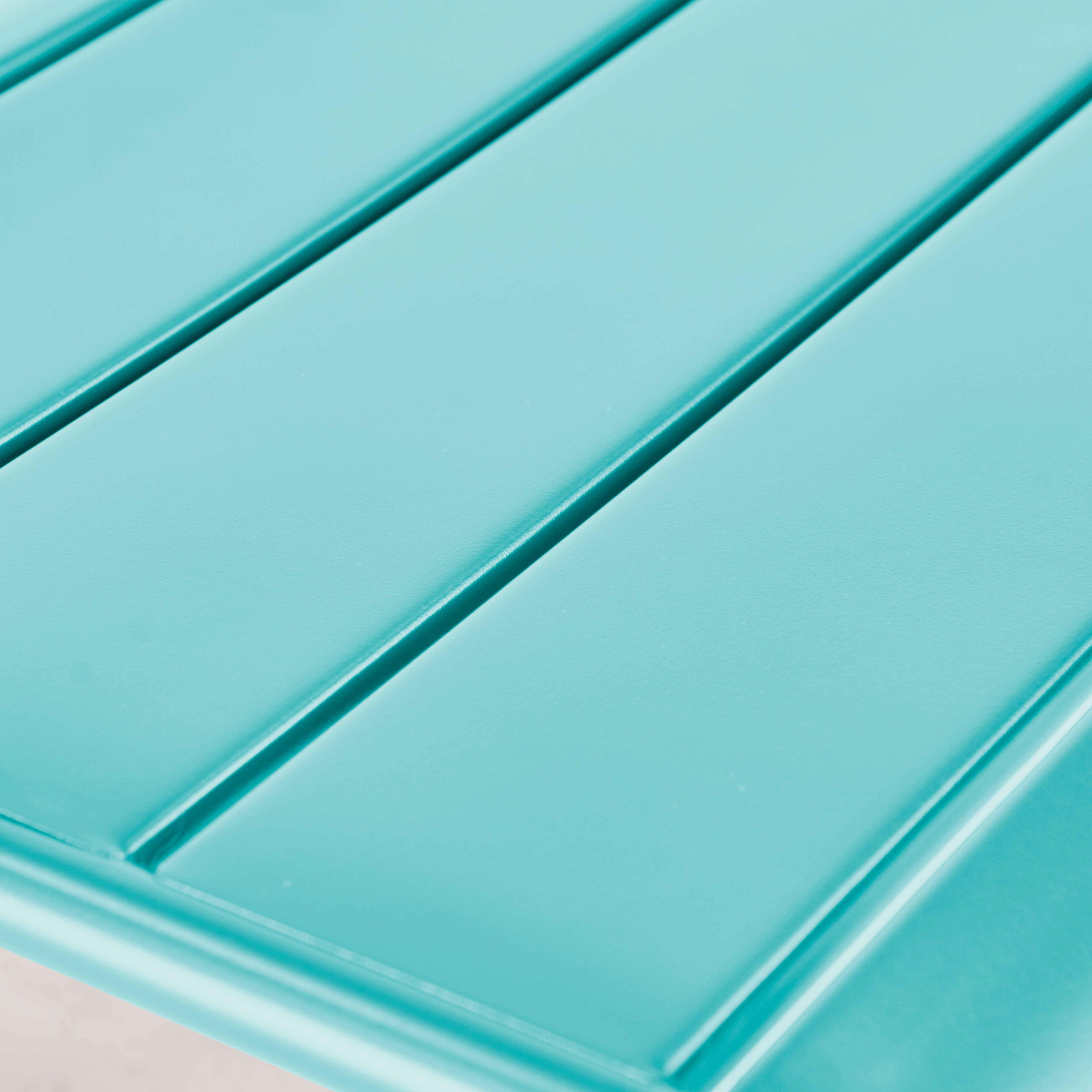 Nahaufnahme einer hellblauen Tischplatte mit Lamellen.