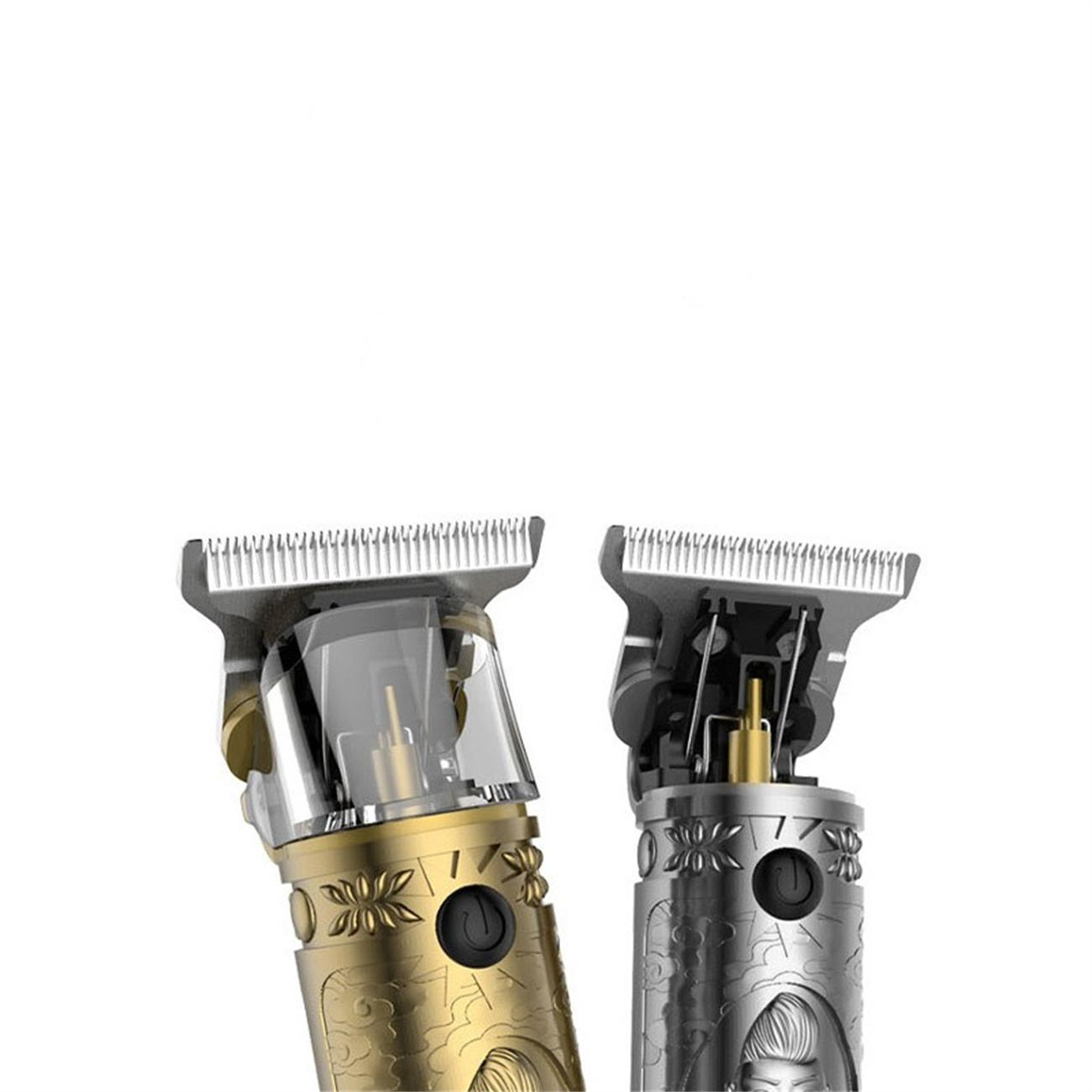 Zwei verzierte elektrische Haarschneider, Gold und Silber, die die Klingenköpfe zeigen.