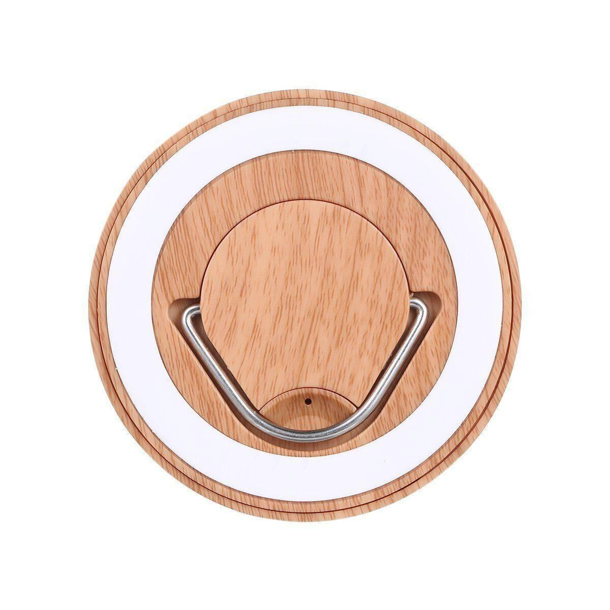 Draufsicht auf einen Sockel mit Holzstruktur, weißem Ring und Metallgriff.