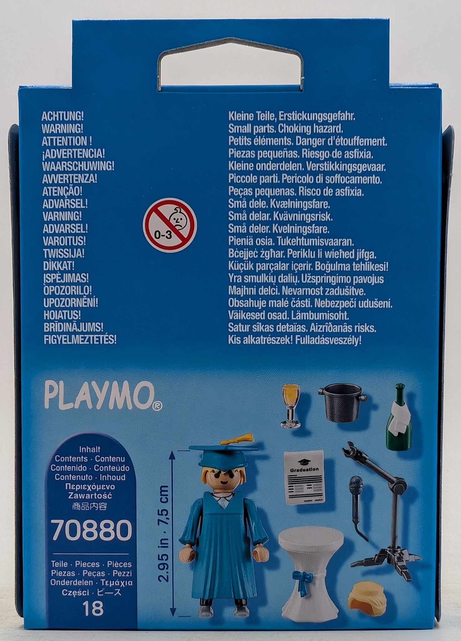 Tył pudełka Playmobil. Zawiera ostrzeżenia w różnych językach. Pokazuje figurkę i akcesoria Playmobil związane z ukończeniem szkoły.