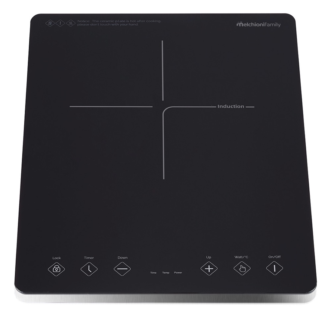 Czarna płyta indukcyjna z przyciskami sterowania. Białe linie wskazują strefy gotowania. Ostrzeżenie: płyta jest gorąca po gotowaniu.