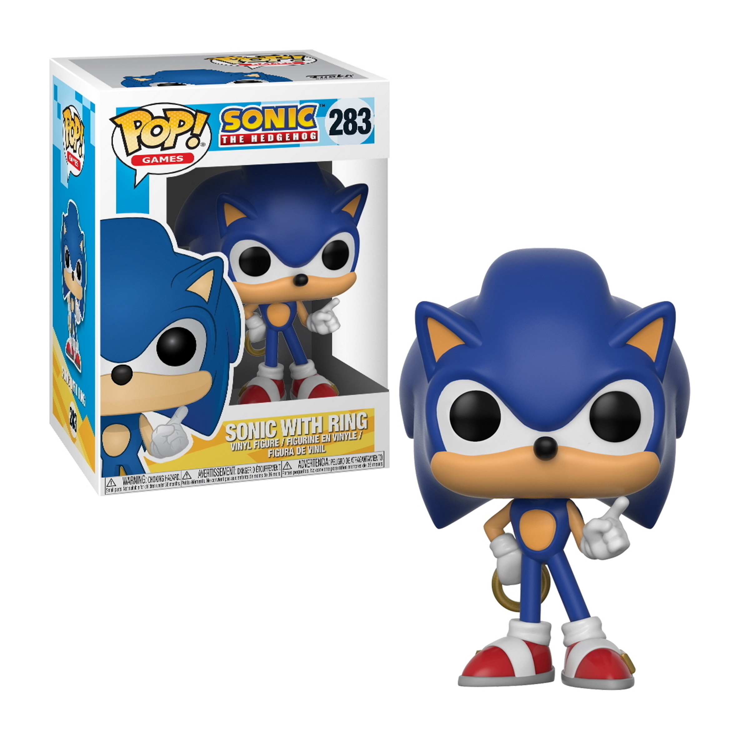 Niebieska figurka Sonica trzymająca pierścień, pudełko po lewej stronie. Sonic stoi.