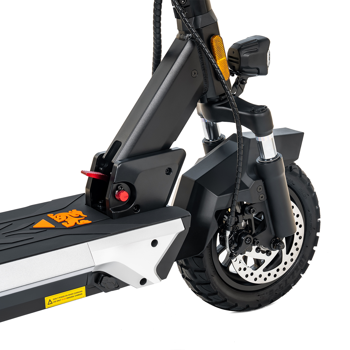 Zbliżenie przedniego koła i zawieszenia hulajnogi elektrycznej. Ma czarną oponę i hamulec tarczowy.