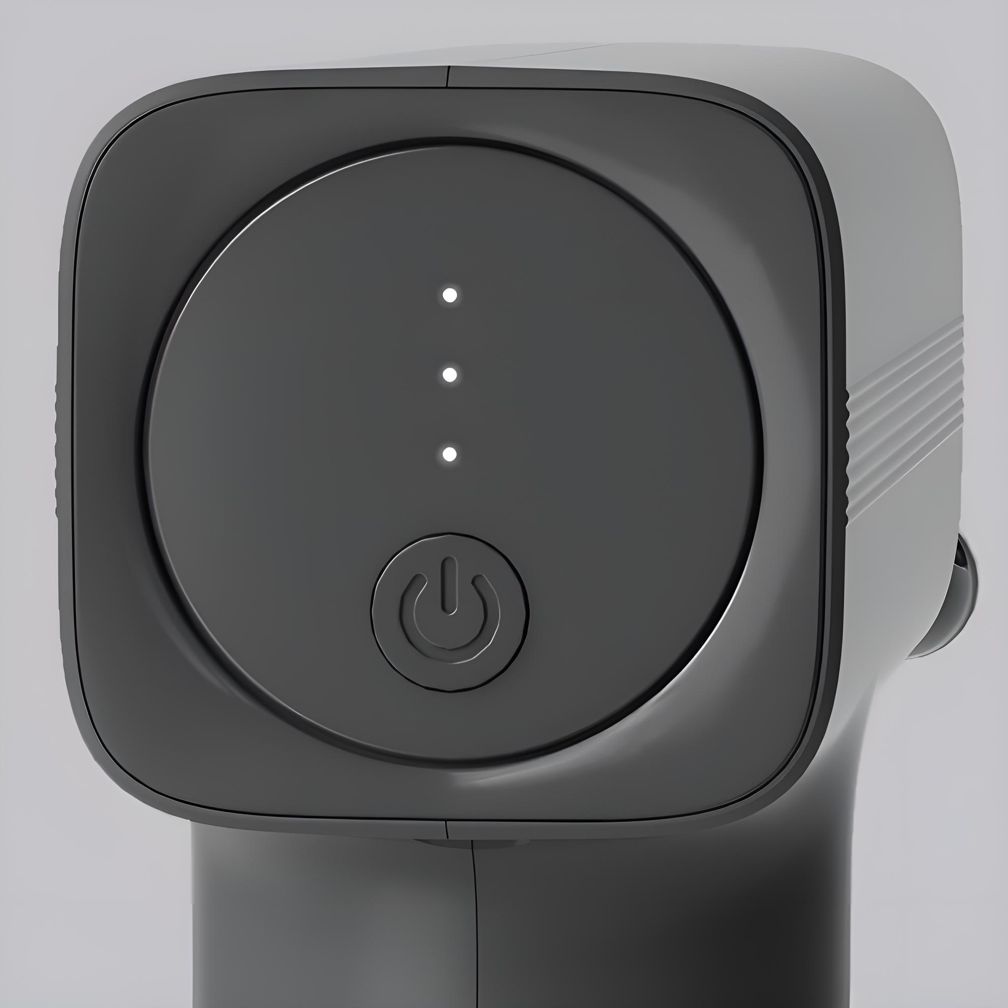Nahaufnahme des Power-Button-Bereichs einer schwarzen Massagepistole. Drei weiße Lichter sind sichtbar.